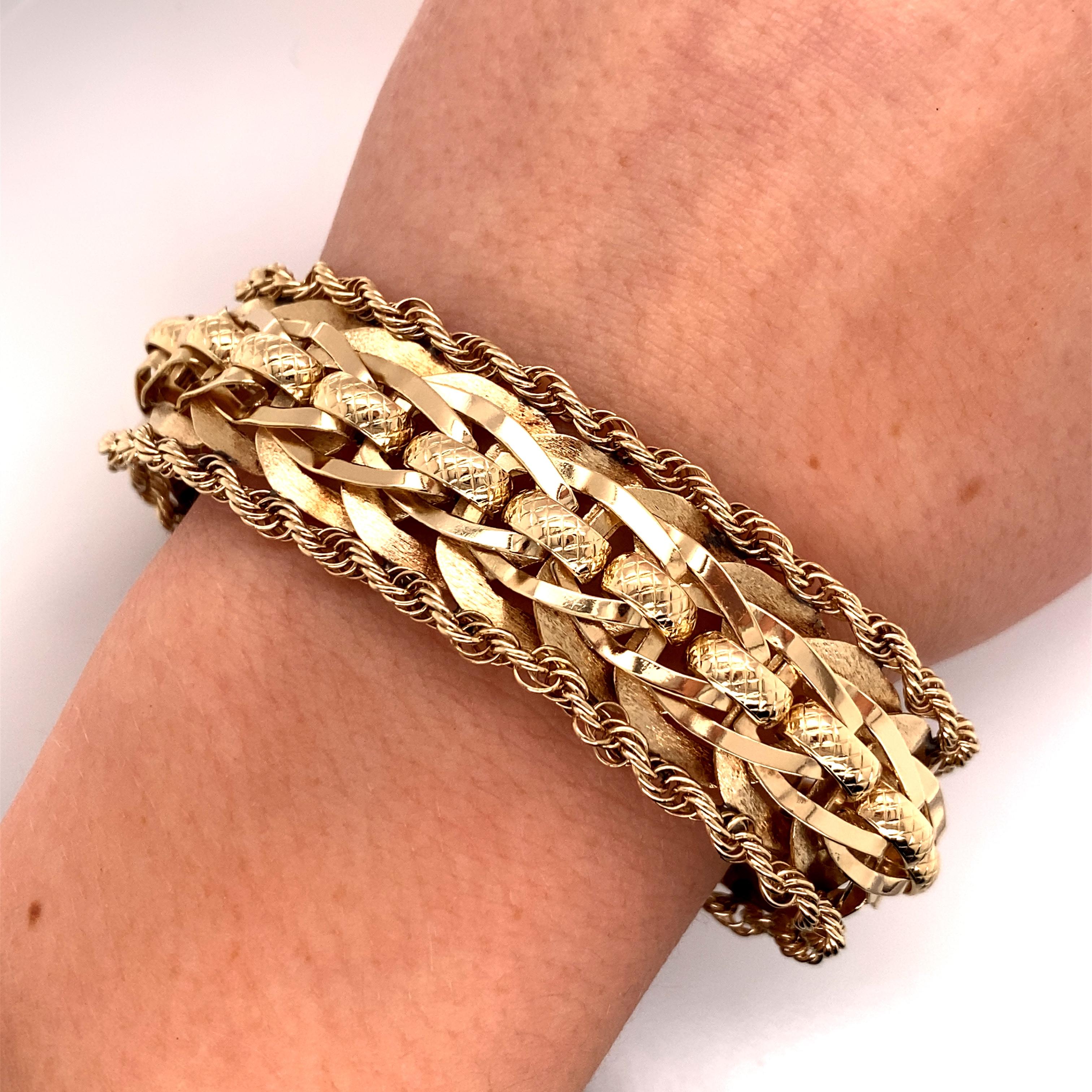 Vintage 1960s 14 Karat Yellow Gold Wide Link Bracelet with Rope Edge - The bracelet measure 7.15 inches long and 3/4 inch wide and features a hidden clasp with a figure 8 safety. The bracelet weighs 39 grams.