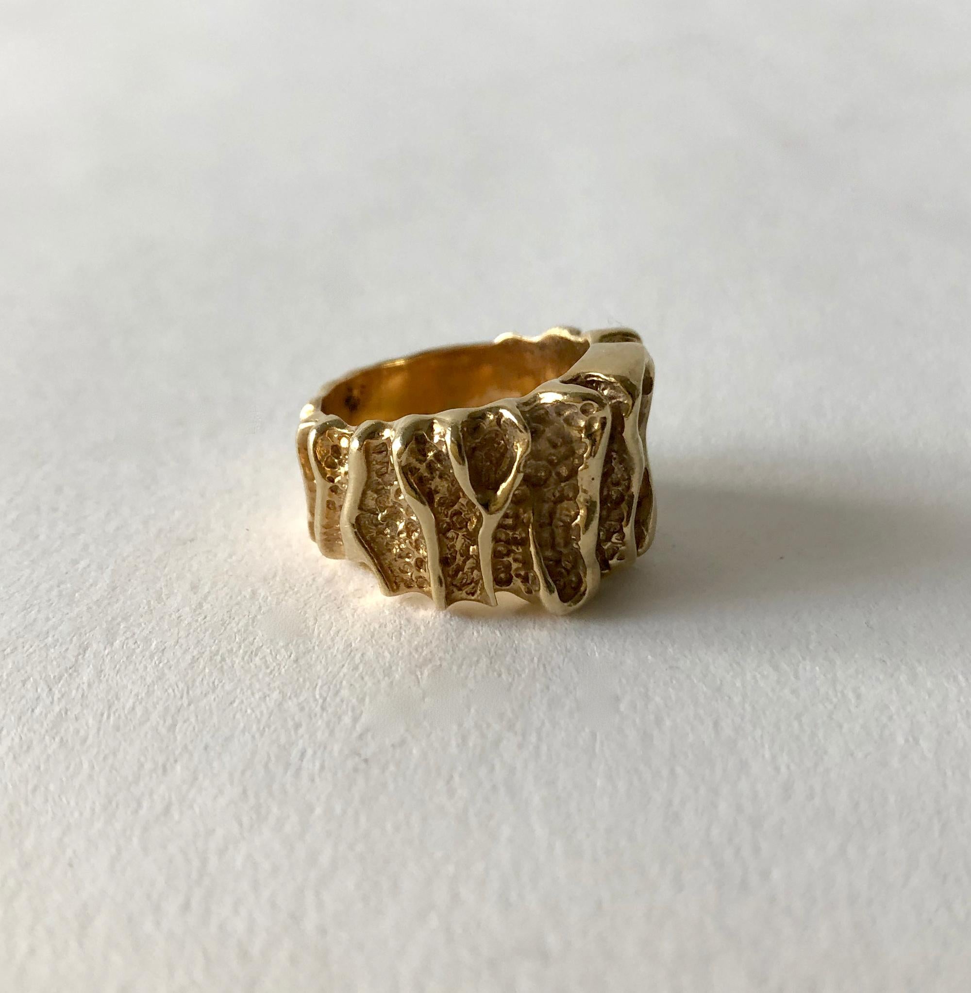 14K gold wide band ring with bark like texture, circa 1960's. Ring measures just over 1/2