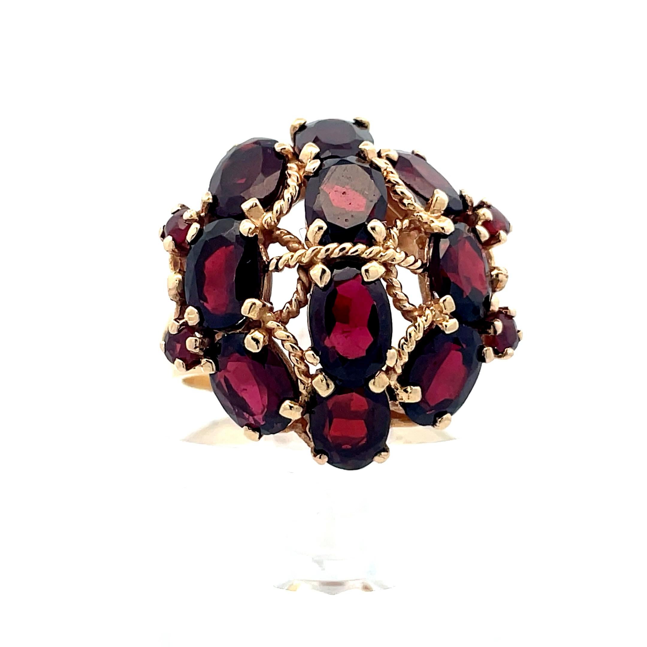 - 14K yellow gold 
- 6.36 cttw Garnet 
- 1960s 
- 11.03 grams 

This is a beautiful cluster ring from the 1960s made in 14k yellow gold with beautiful garnet clusters. This ring contains 10, beautiful oval cut garnets, as well as 4 round cut
