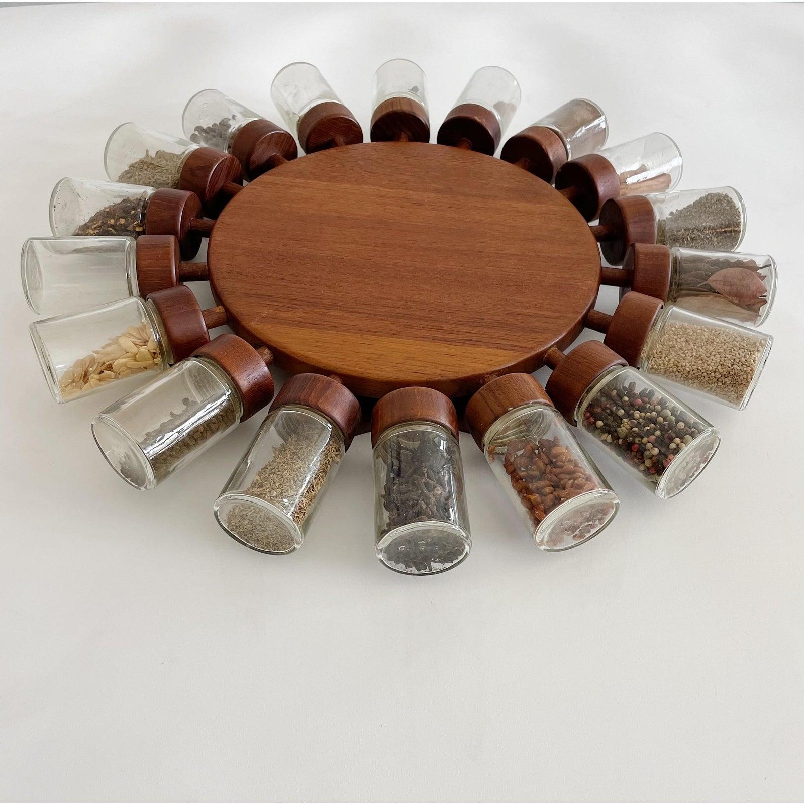 Designed to hang on the wall this rotating spice rack spins to the spice you need then just unscrew the glass jar and voila, you have your spices. Made in 1964 by Digsmed of Denmark, with 18 glass spice jars on a teak frame. This is the largest most