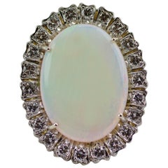 1960s 18 Karat Gold Oval Opal with a Halo of Round Diamonds Ring