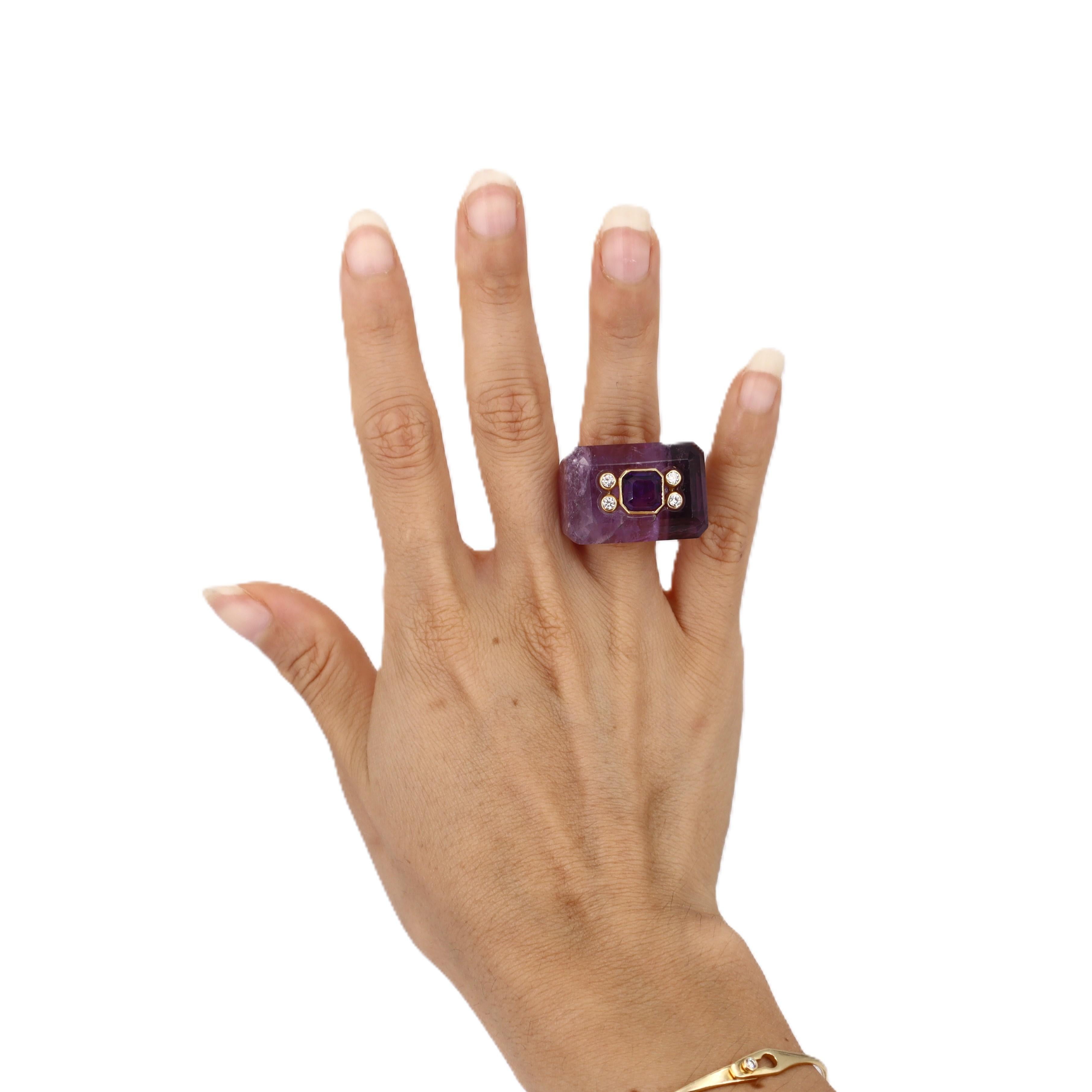 This extraordinary 1960's statement ring is a true work of art, masterfully carved from a single piece of solid amethyst. Crafted in rich 18kt gold, this museum-quality piece features four brilliant European-cut diamonds that create stunning