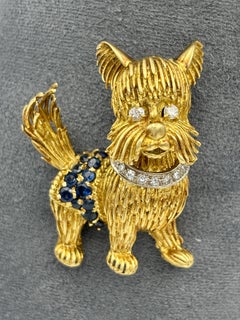 1960s 18k gold dog brooch with diamonds and emeralds