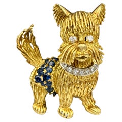 1960s 18k gold dog brooch with diamonds and emeralds