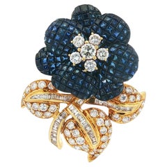 1960s 18K Mystery-Set Sapphire Flower Brooch With Diamond Leaf and Stem