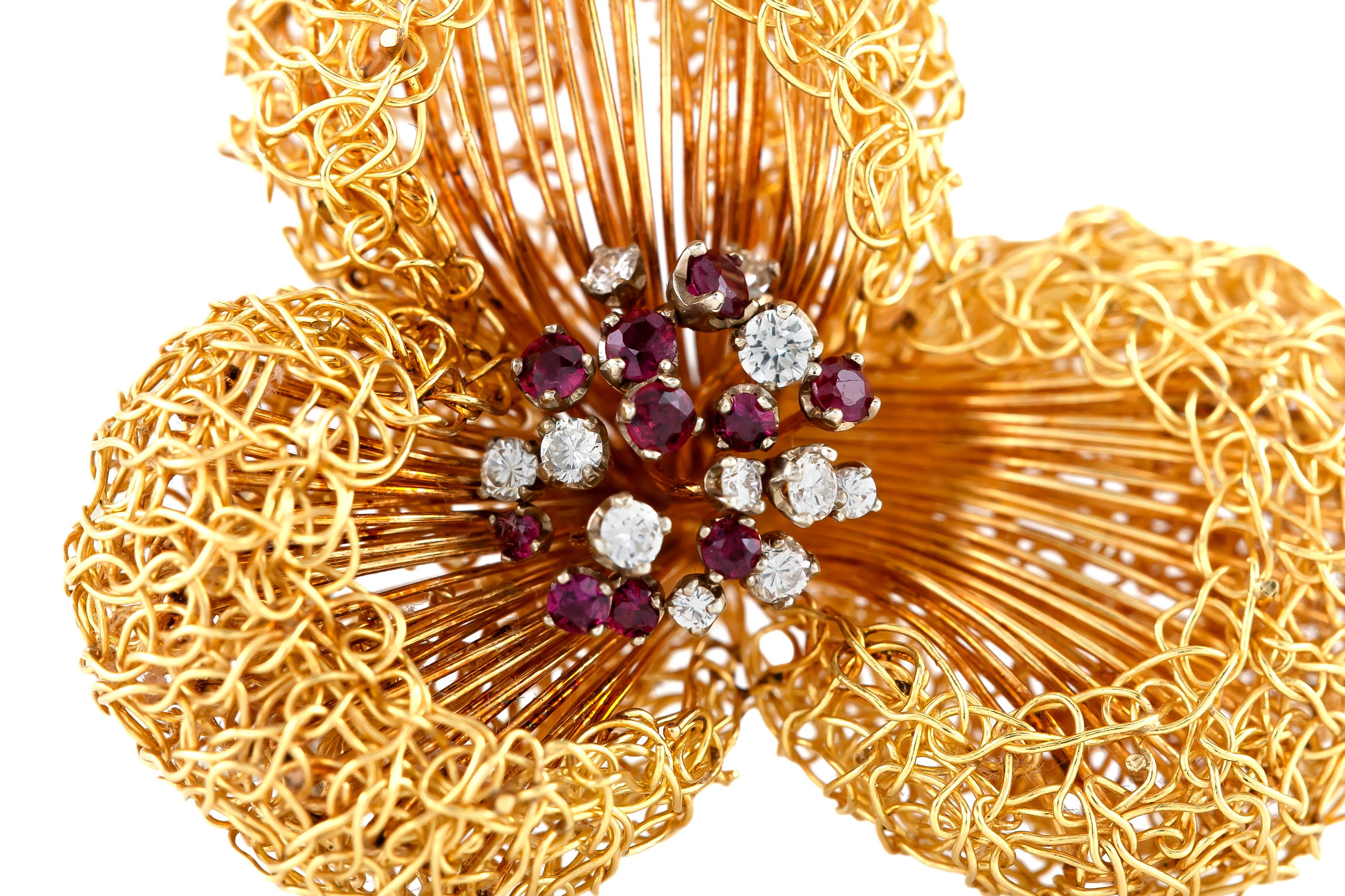 The brooch is finely crafted in 18k yellow gold with rubies weighing approximately total of 0.65, diamonds weighing approximately total of 0.60 carat and the total weight of the brooch is 31.4 dwt.