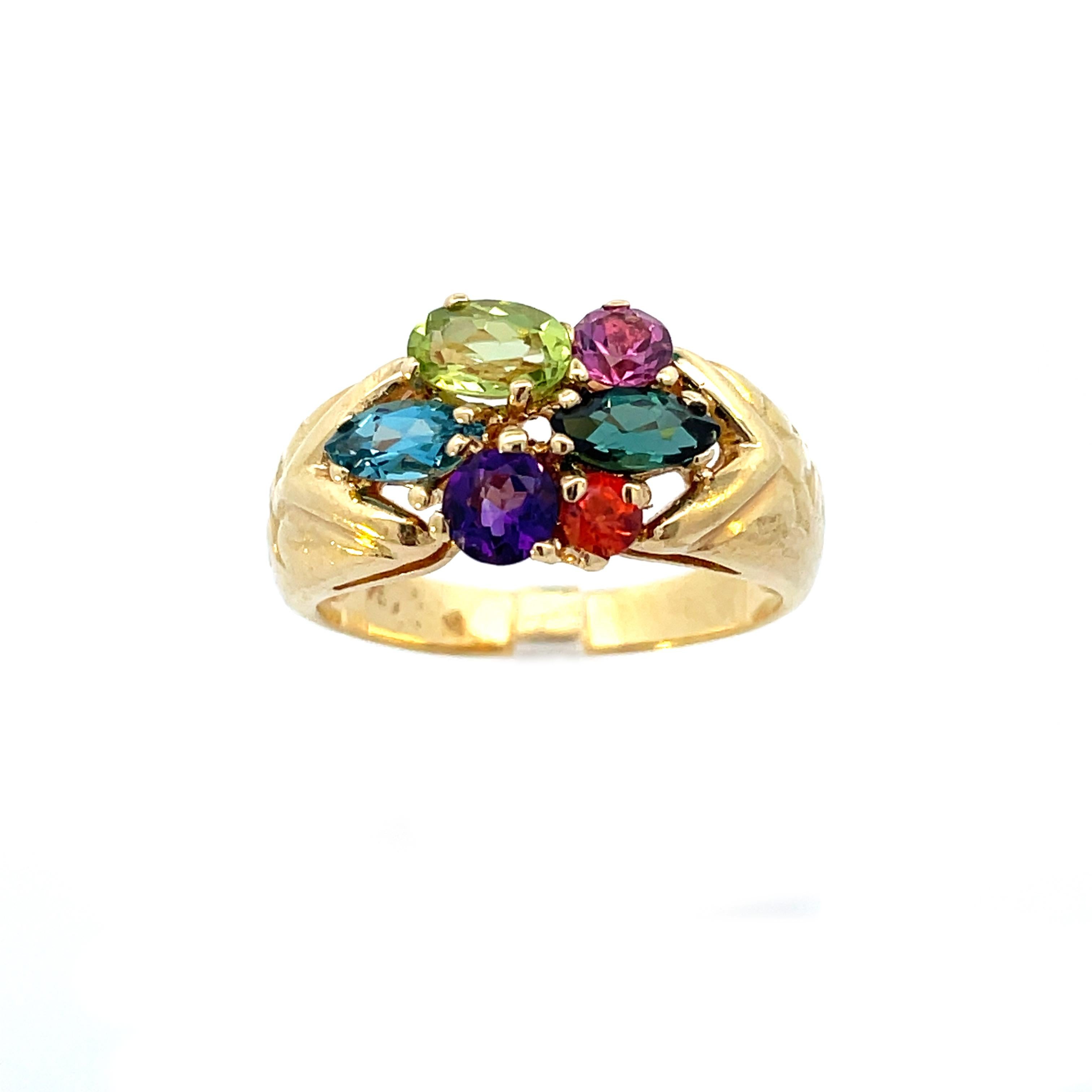 This is a stunning vintage ring signed by famed H. Stern, crafted in beaming 18K yellow gold showcases a dazzling group of vibrant gemstones. This ring is set with six multicolored gemstones in various cuts and set in a unique pattern. The ring