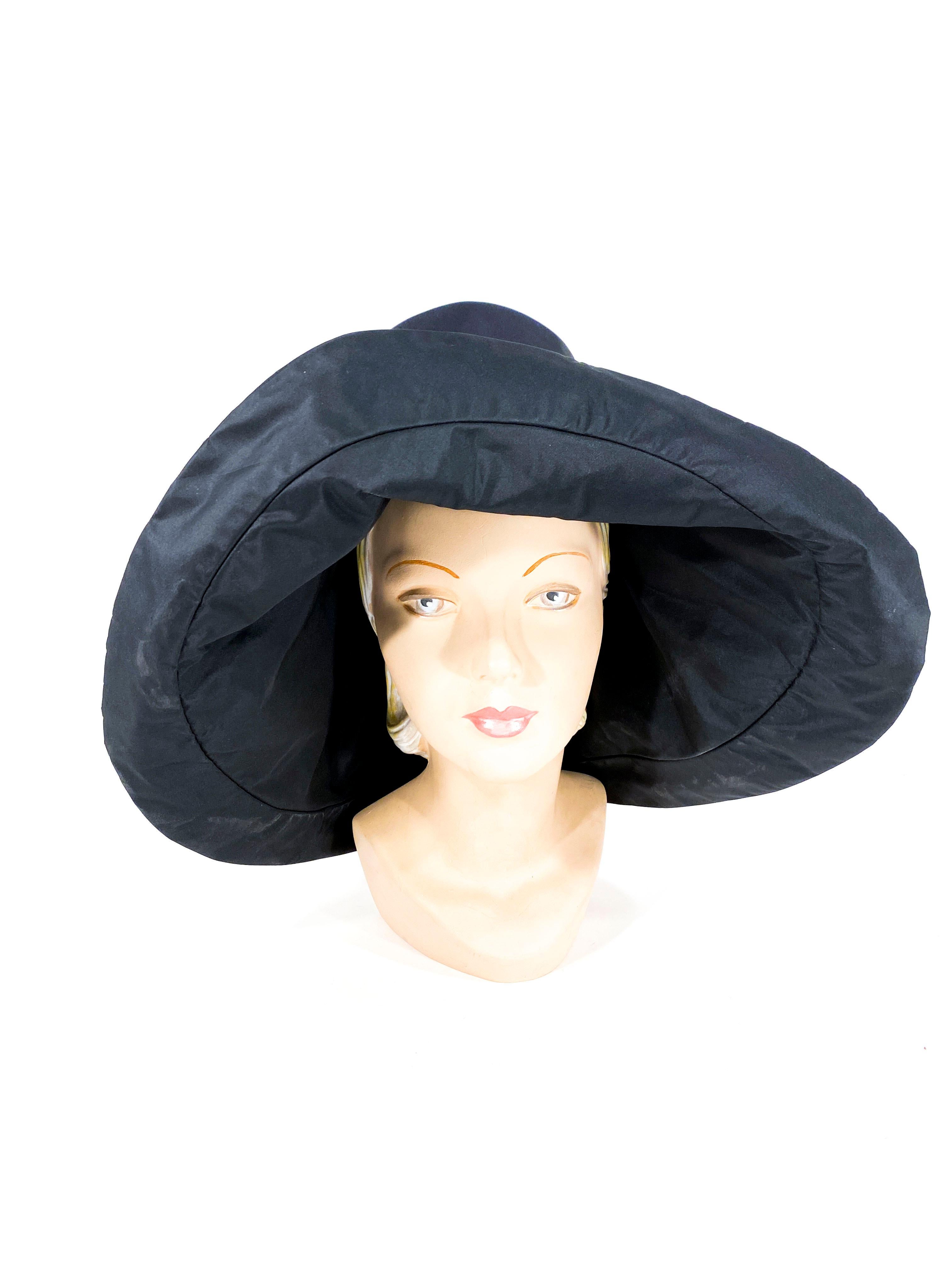 Late 1960s to early 1970s black unstructured floppy wide-brimmed day hat with a high crown, narrow grosgrain hatband, interior lining This high-fashion hat has the original Saks Fifth Ave. label on the interior hat band.