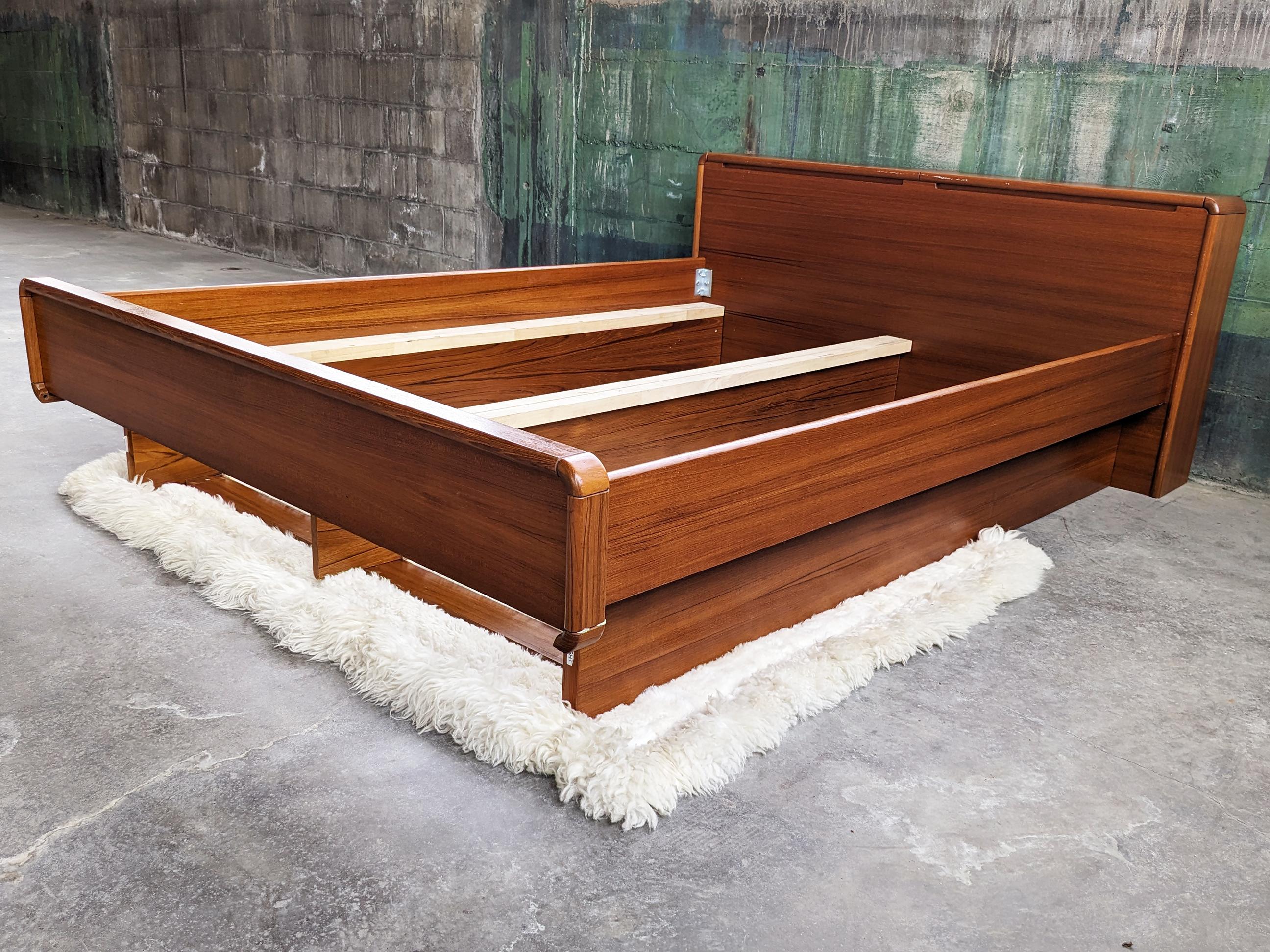 Very beautiful teak danish Queen bed with two pillow or extra linen storage compartments in the headboard + Two underneath drawers.

Optional** Additional matching end table, can be purchased separately. Inquire if interested, See image 3 for