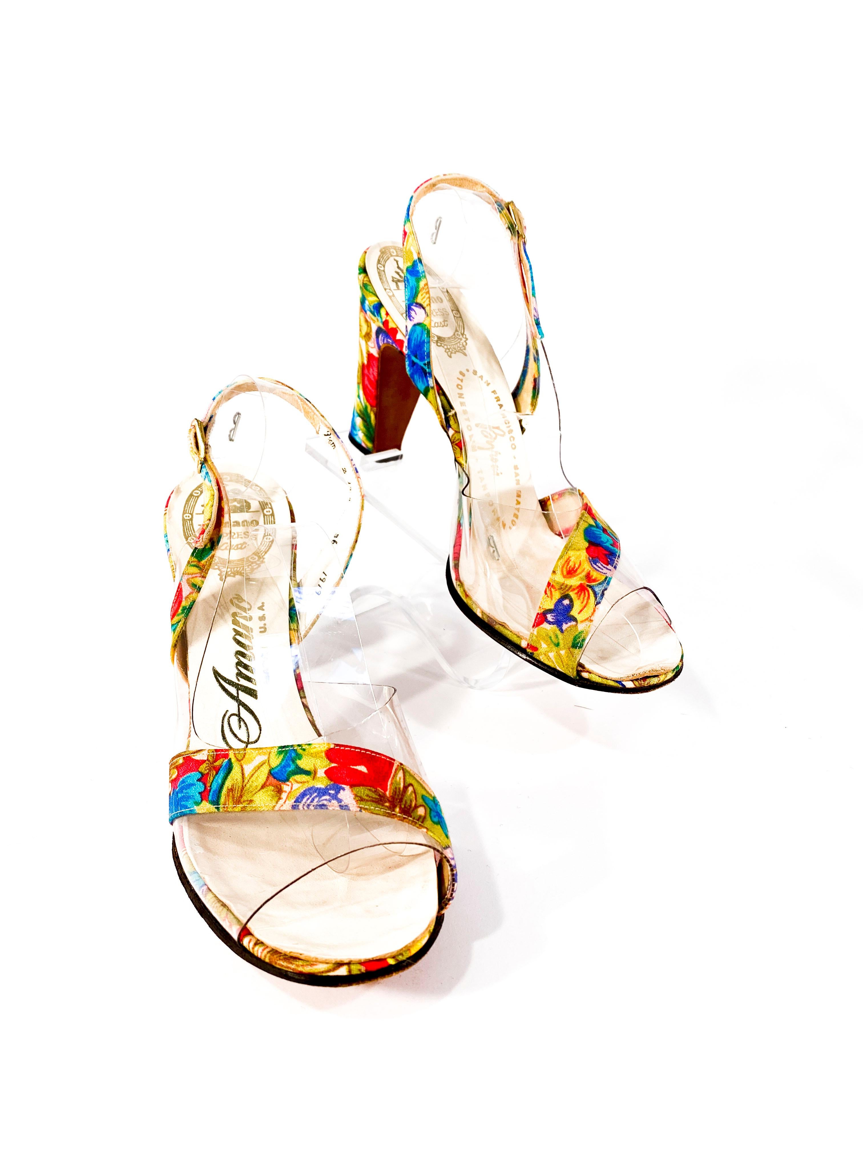 Late 1960s to early 1970s vibrantly printed floral heels with matching handbag. The peptone heels have clear vinyl accents and the envelope purse has a double gold brass chain that can be worn short or long. The handbag is lined in twill with brass