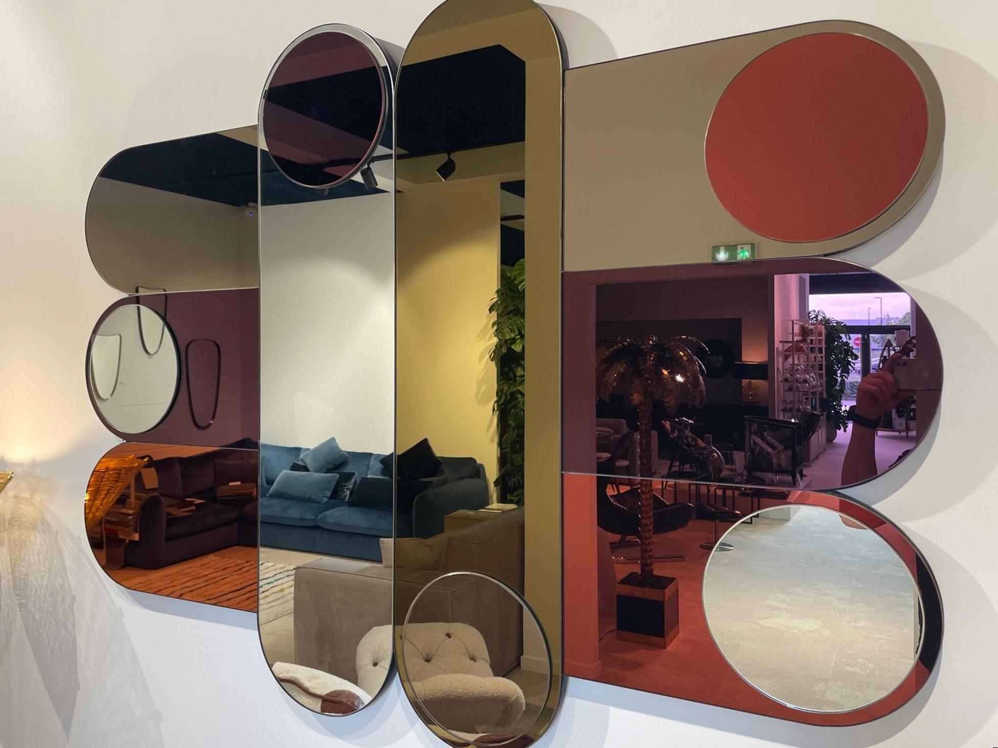 1960s 1970s Italian Design Style Large Colored Graphic Mirror composed of an curved and round structure adorned with several mirrors in different colors like purple, pink, orange, silver and gold. The built-in fasteners are designed so that you can