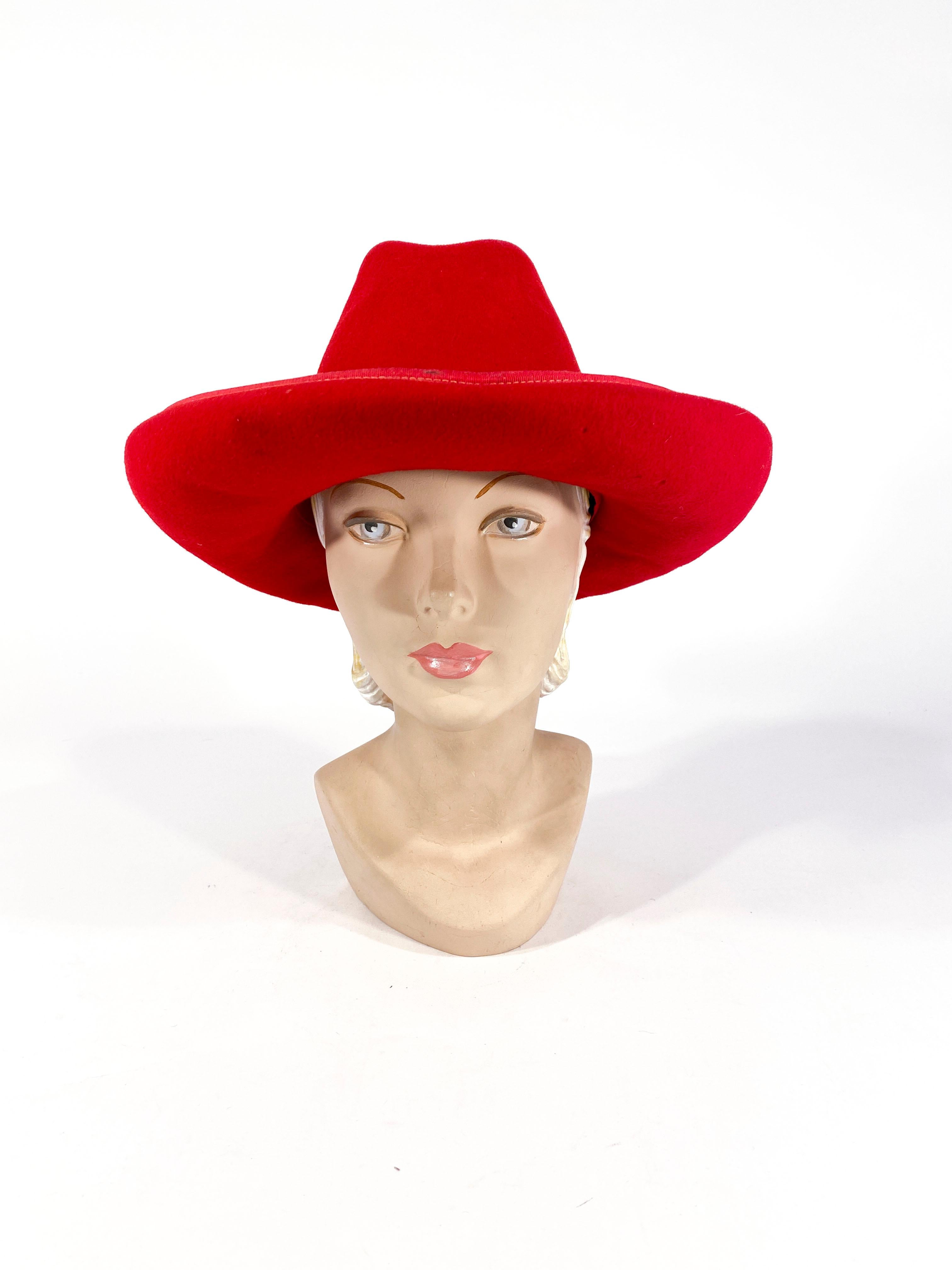 Late 1960s to early 1970s red fur felt hat with wide rolled brim trimmed with grosgrain to match the hatband. The high crown of this western hat is hand-sculpeted and structure with an interior band.