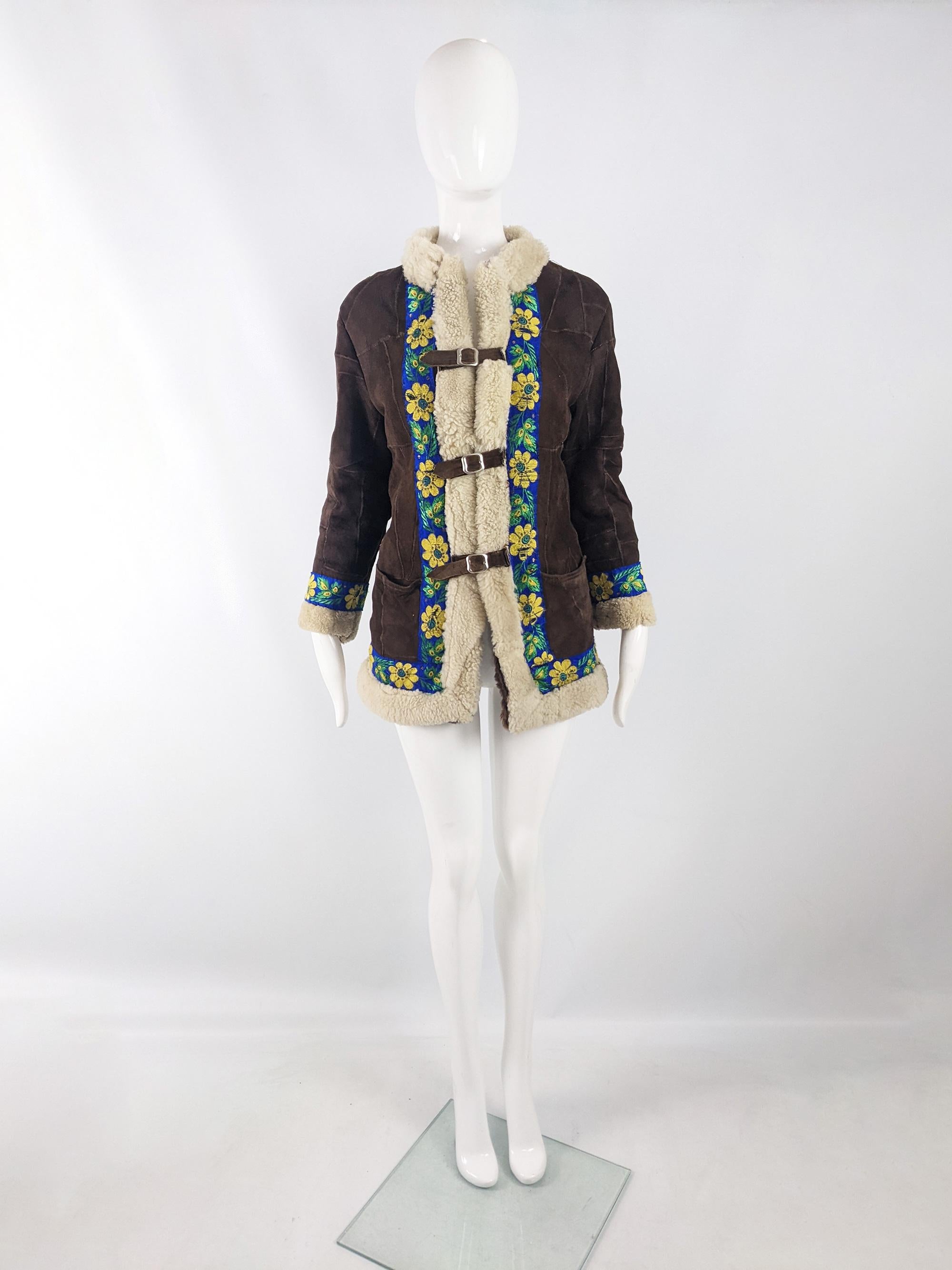 An incredible and rare vintage womens Afghan coat from the late 60s / early 70s. This coat gives a great twist on the usual Afghans you see, made from a patchwork of sheepskins with a cream shearling front that is highlighted with an embroidered