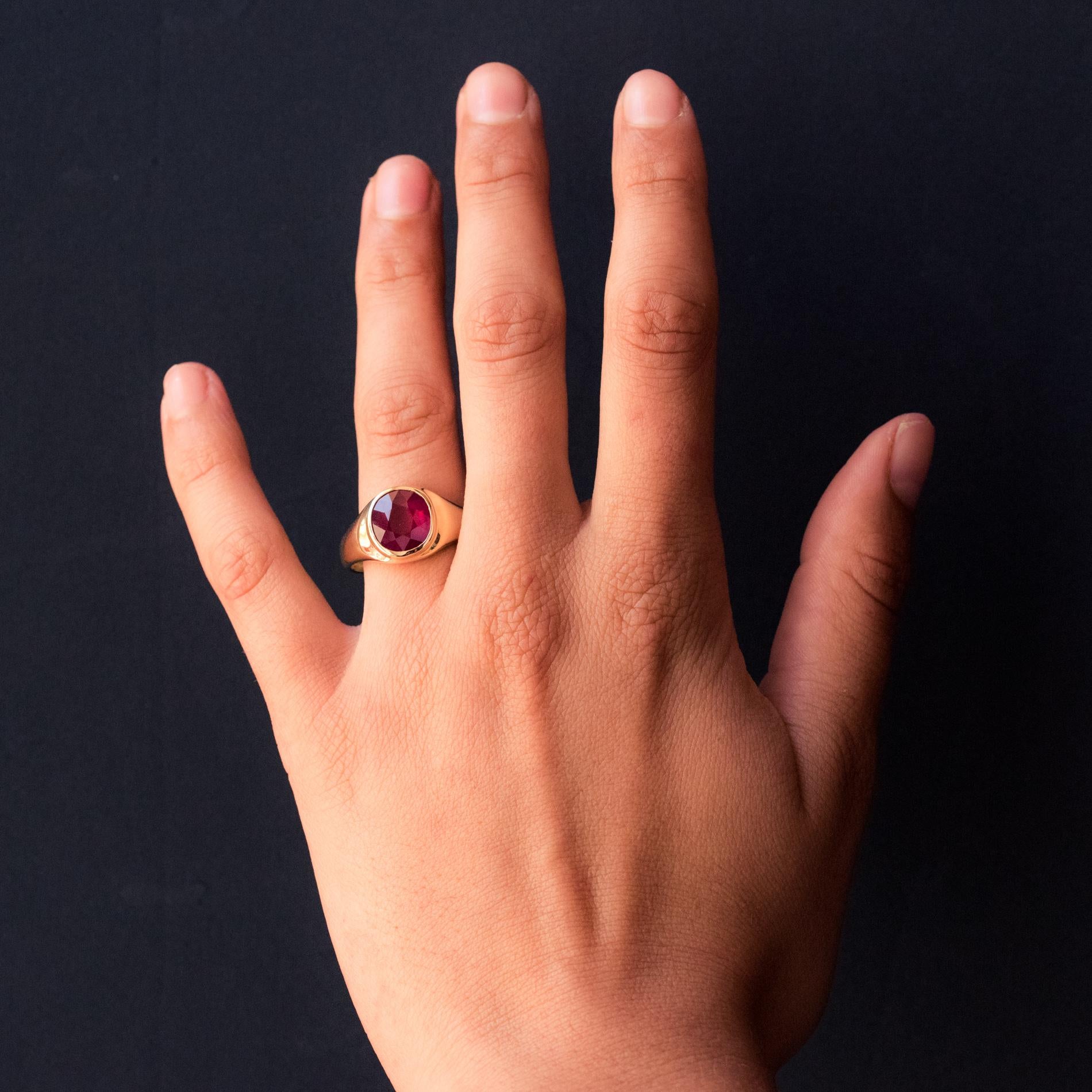 Ring in 18 karat yellow gold.
Magnificent bangle ring, it is closed set on its top with a treated cushion- cut ruby.
Total weight of the ruby: approximately 5.05 carats.
Height: 12.4 mm, width: 10.8 mm, thickness: approximately 4.5 mm, width of the