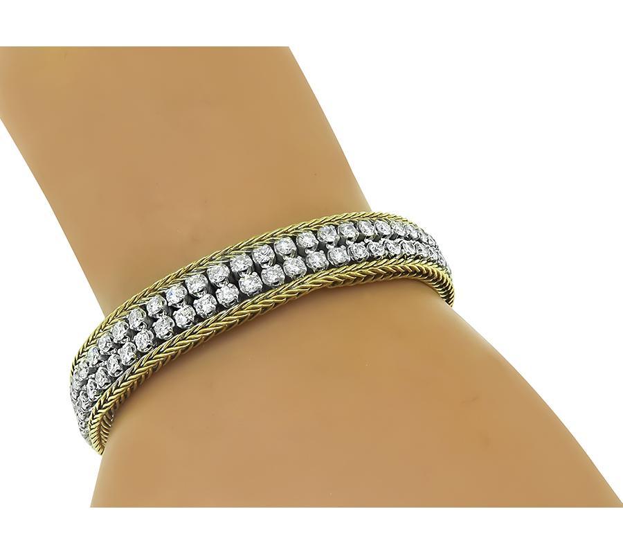 This is an amazing 14k yellow and white gold bracelet from the 1960s. The bracelet is set with sparkling round cut diamonds that weigh approximately 6.53ct. The color of these diamonds is G with VS2-SI1 clarity. The bracelet measures 11mm in width