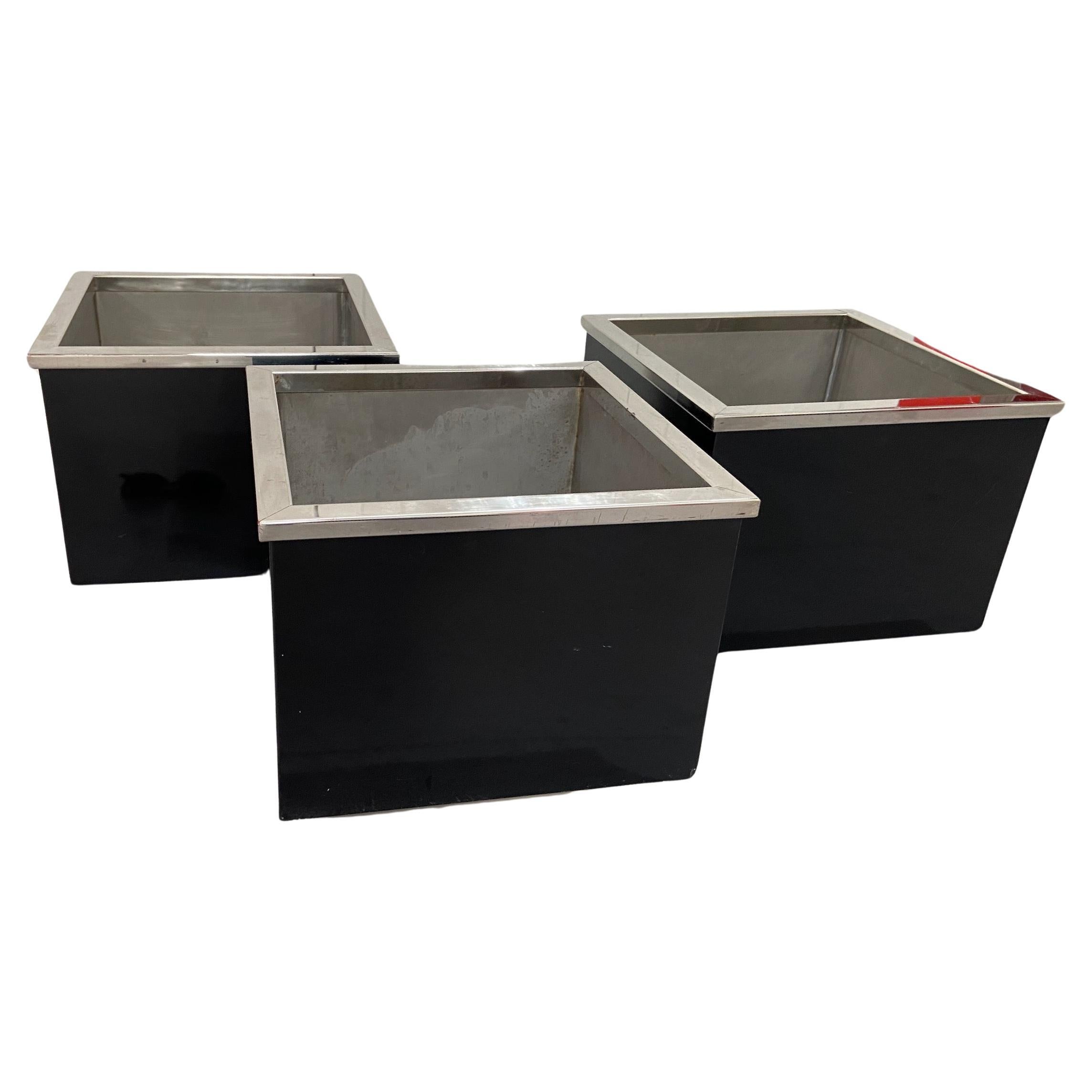 Mid-century black enamelled metal planters with chrome rim and stainless steel base and lining, in the manner of Willy Rizzo. Very good quality and design. 
3 planters available.