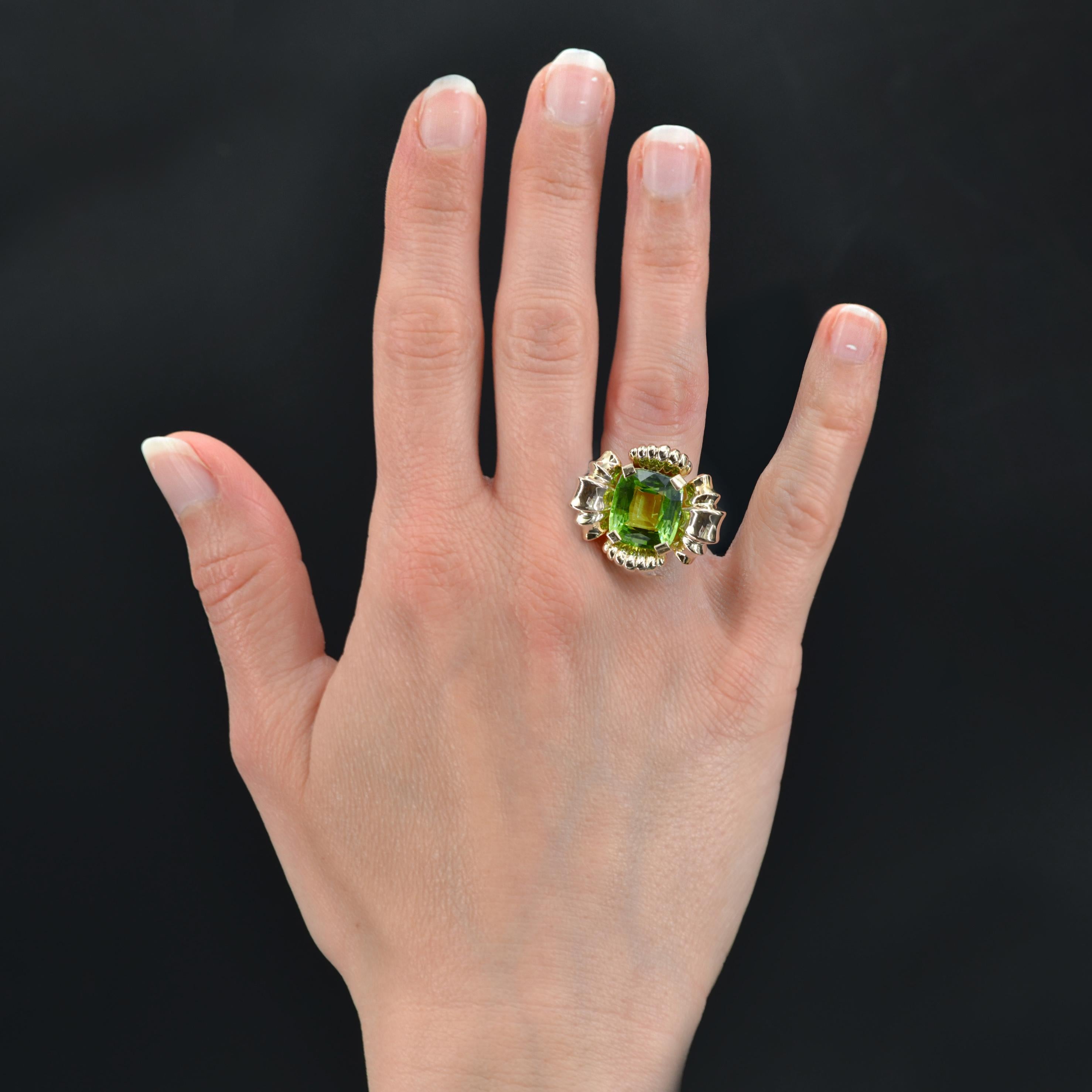 Ring in 18 karat rose gold, owl hallmark.
Important retro ring in rose gold, its setting represents a flower whose heart is decorated with an important cushion-cut peridot set with 4 flat claws. The start of the ring is gadrooned.
Weight of the