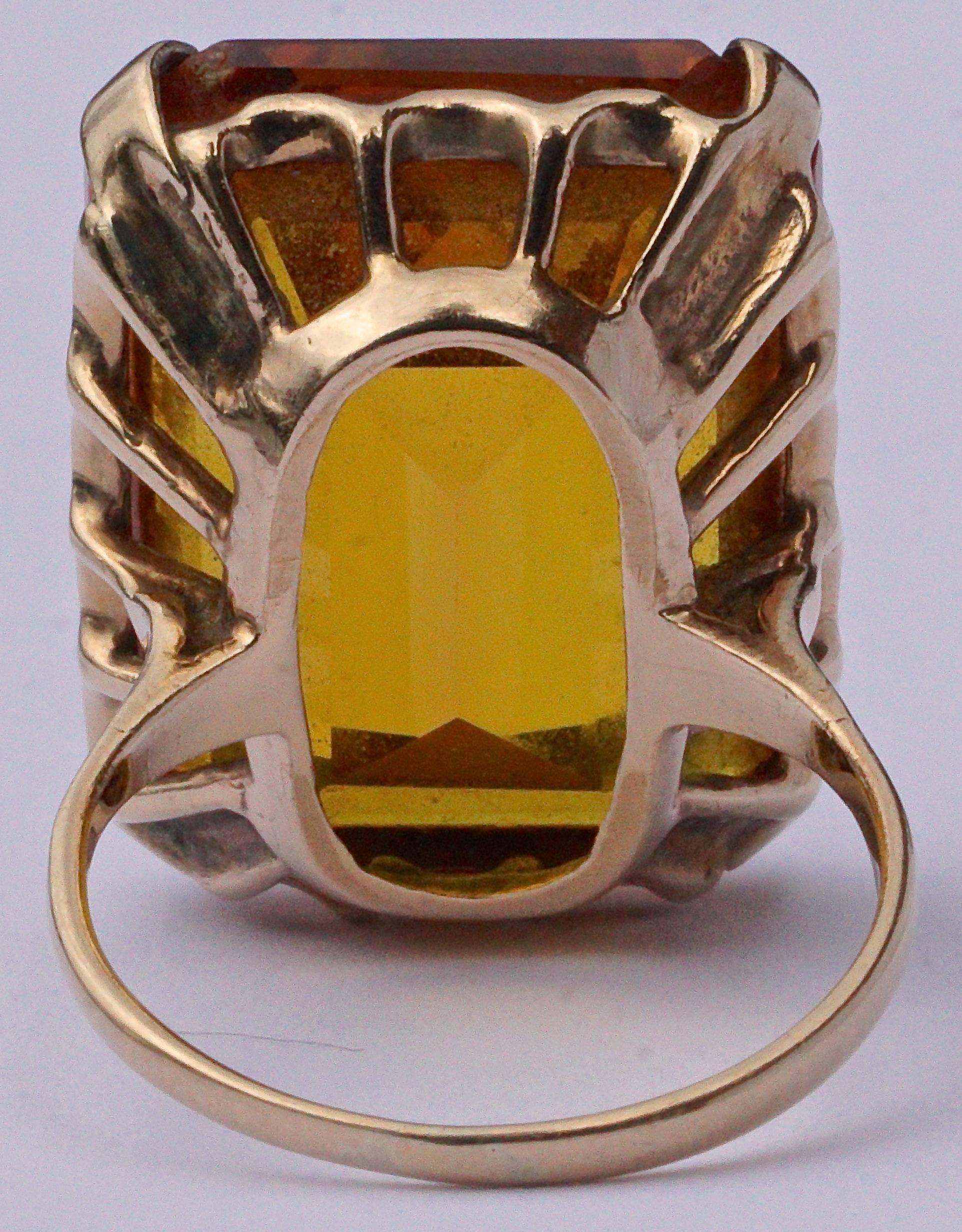 Fabulous 9ct gold ring with a large emerald cut synthetic sapphire, ring size UK K, US 5 1/4, inside diameter 1.6cm / .6 inch. The beautiful burnt orange synthetic sapphire measures 2.1cm / .8 inch by 1.6cm / .6 inch, and is held with claws in a