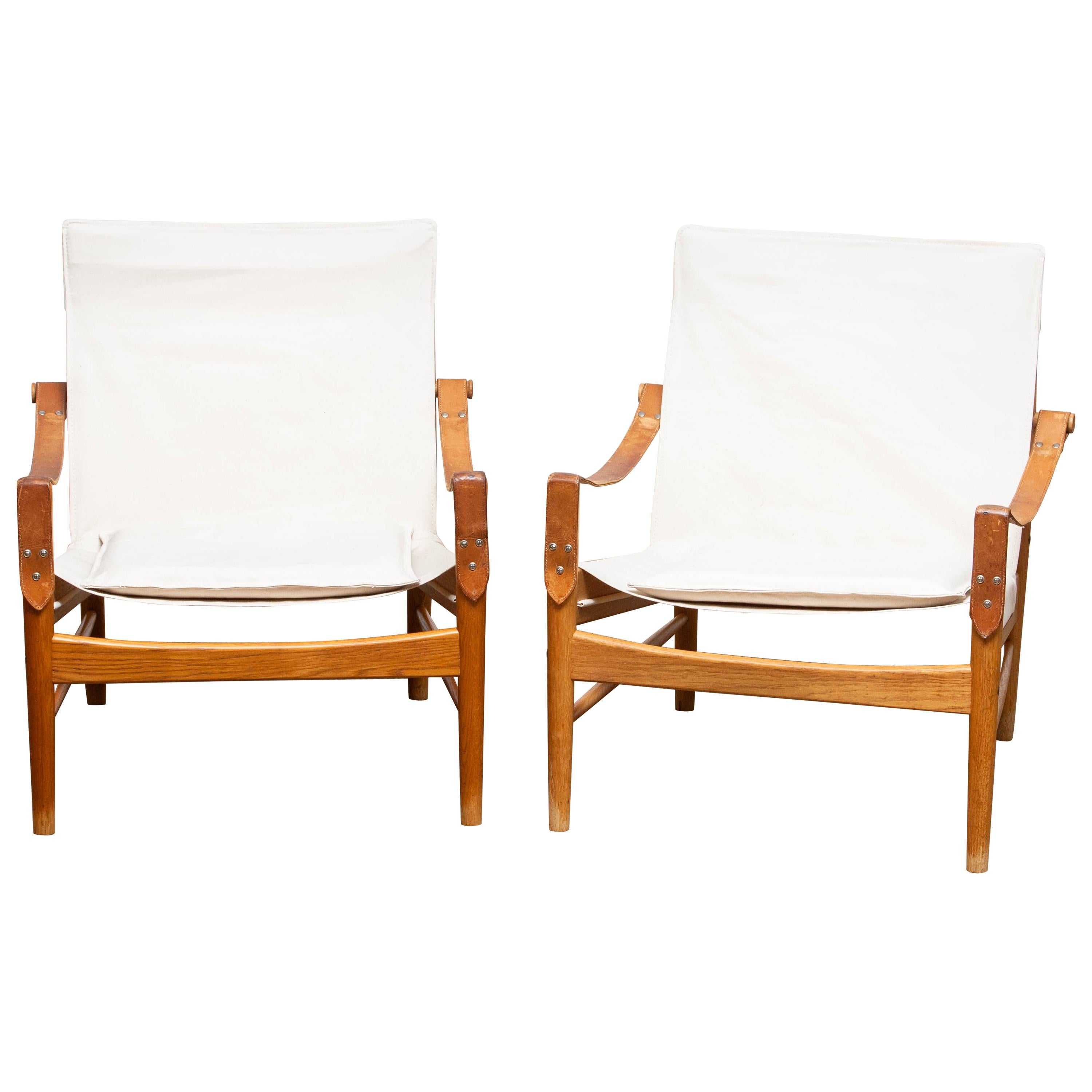 Beautiful pair of safari chairs designed by Hans Olsen for Viska Möbler in Kinna, Sweden.
These chairs are made of oak with a new canvas upholstery.
They are in a wonderful condition and marked.
Period: 1960s.
Dimensions: H 81 cm, W 73 cm, D 70