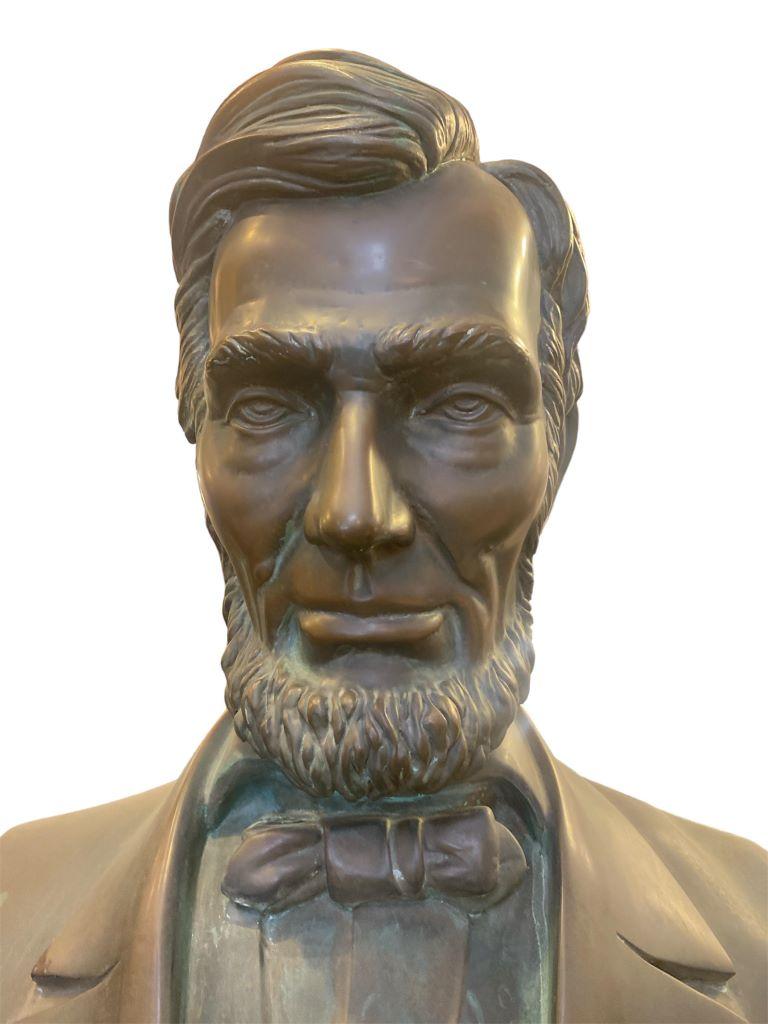 A 3-foot Abraham Lincoln bust sculpture is a detailed representation of the 16th President of the United States. The sculpture features Lincoln's distinctive facial features, including his prominent beard and deep-set eyes. The sculpture captures