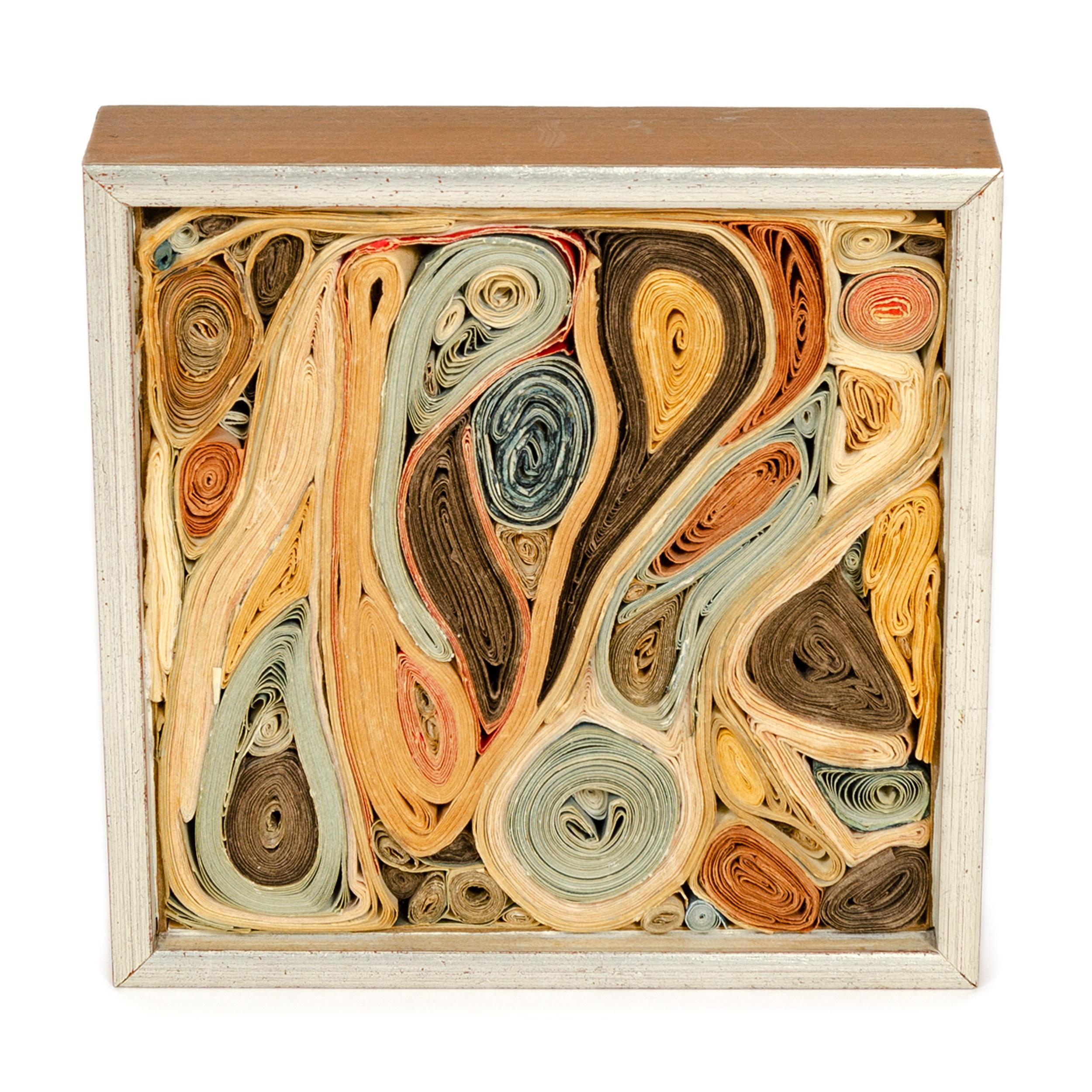 A boxed, abstract construction of colorful quilled paper by American artist Paul Shaub.