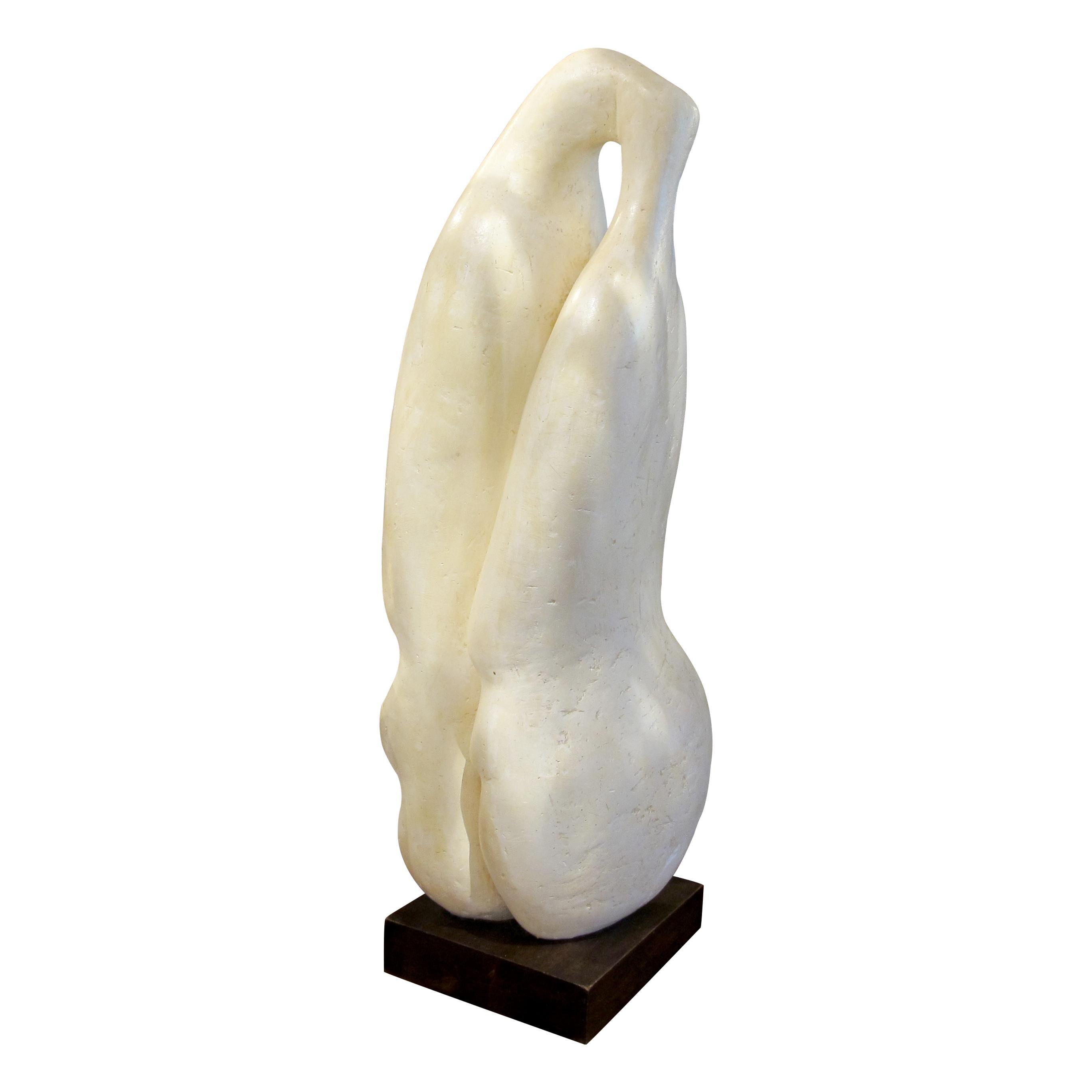 This large abstract plaster sculpture, created by an unknown French artist circa the 1960s, beautifully captures the essence of two lovers entwined in an intimate embrace. The smooth, flowing lines of the figures blend seamlessly, symbolizing unity