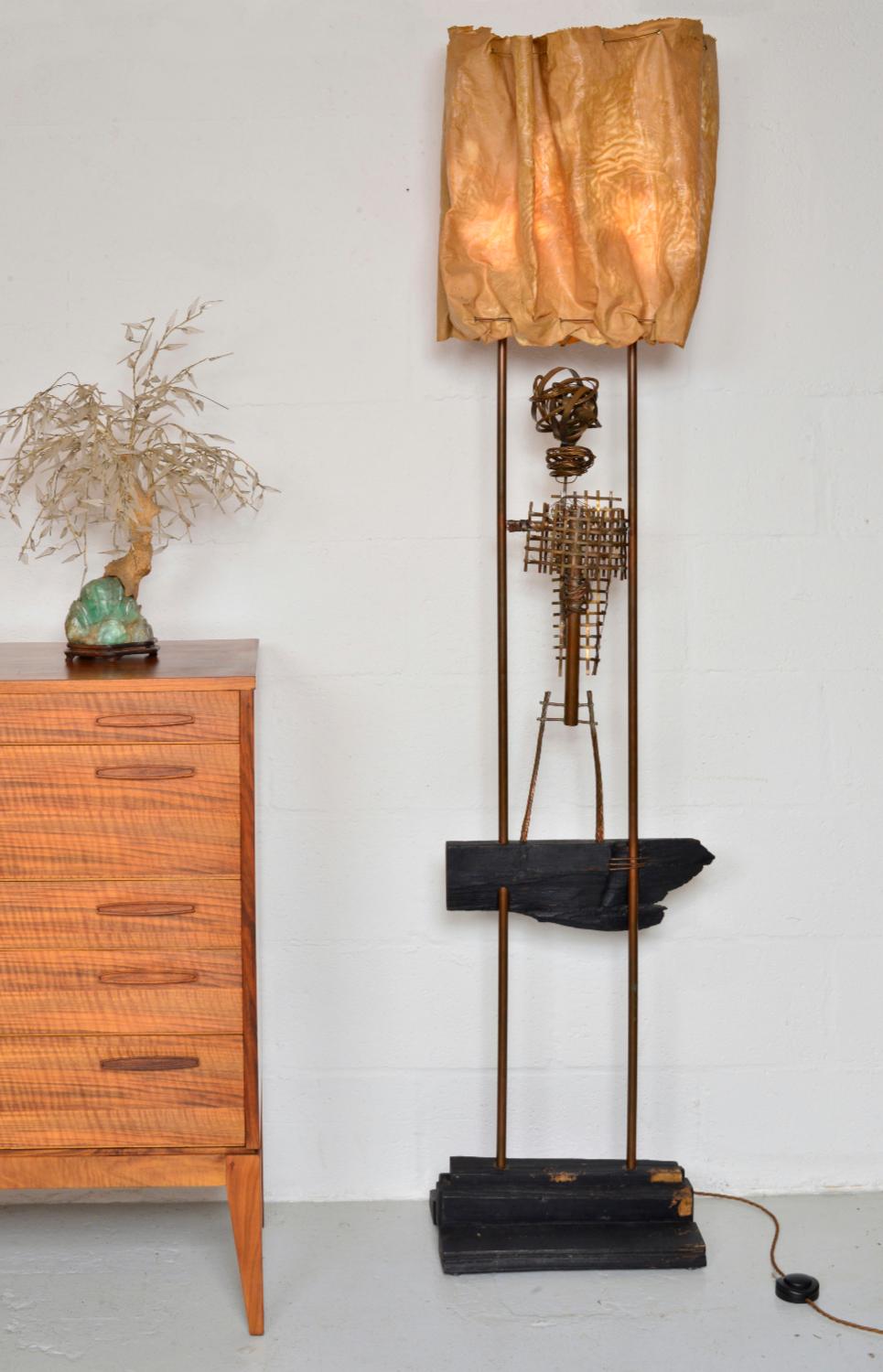 This extraordinary and unique abstract standard lamp in copper, wood and cotton cloth is by renowned British artist David Graves, who was a sculptor, paper restorer and assistant to David Hockney.
Measuring over six-feet tall, the lamp has a stepped