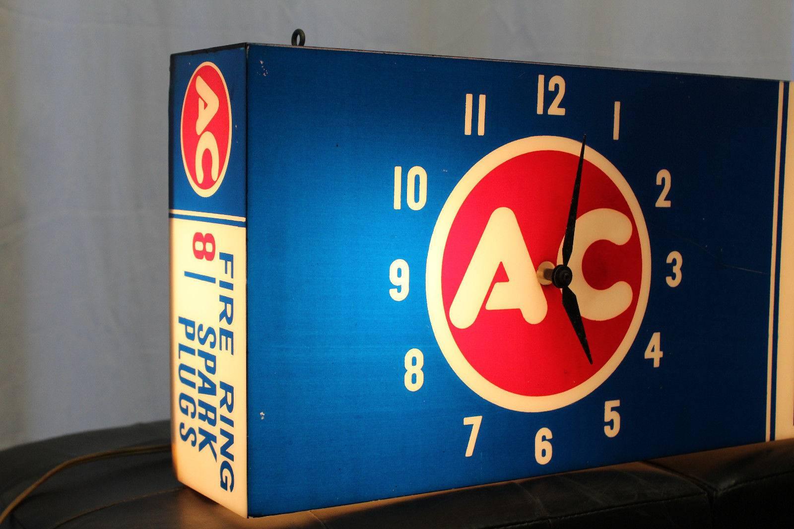 Amazing form of advertising and usage of a clock. Most part stores or auto body shops would normally advertise what they use or sell in store. This is a plastic AC Spark Plug hanging sign that plugs in and lights up. This piece only has a clock on