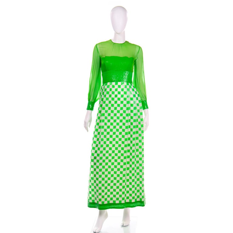This is truly an amazing deadstock Adele Simpson late 1960s evening in green silk with white and green checks and sequins. The sleeves and over blouse on the bodice are silk chiffon, the bodice underneath is strapless and it is covered with green