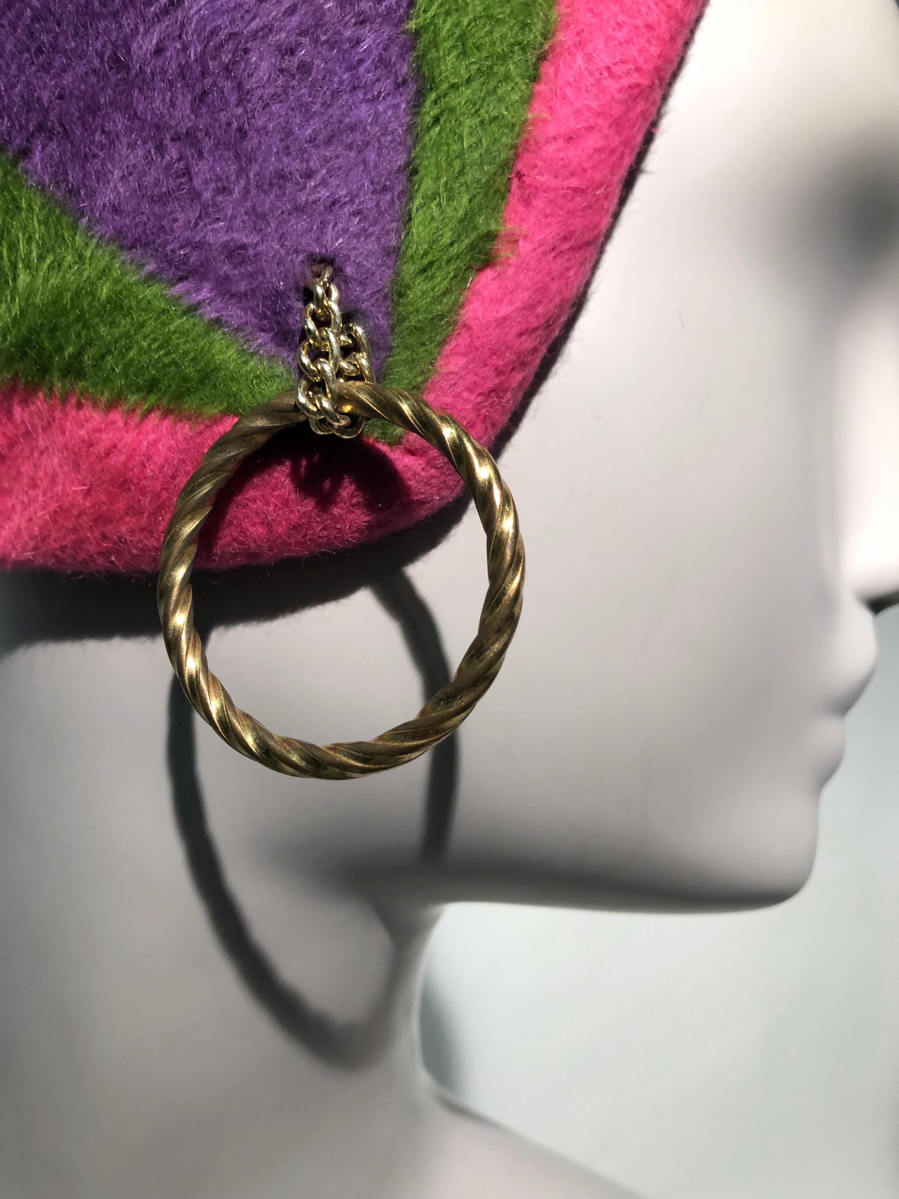 A unique 1960s Adolfo II mod helmet cloche style hat in pink green and purple felt with a gold-tone hoop earring attached on one side, to be worn over the ear. This iconic hat was featured on the cover of Vogue in the 1960s!