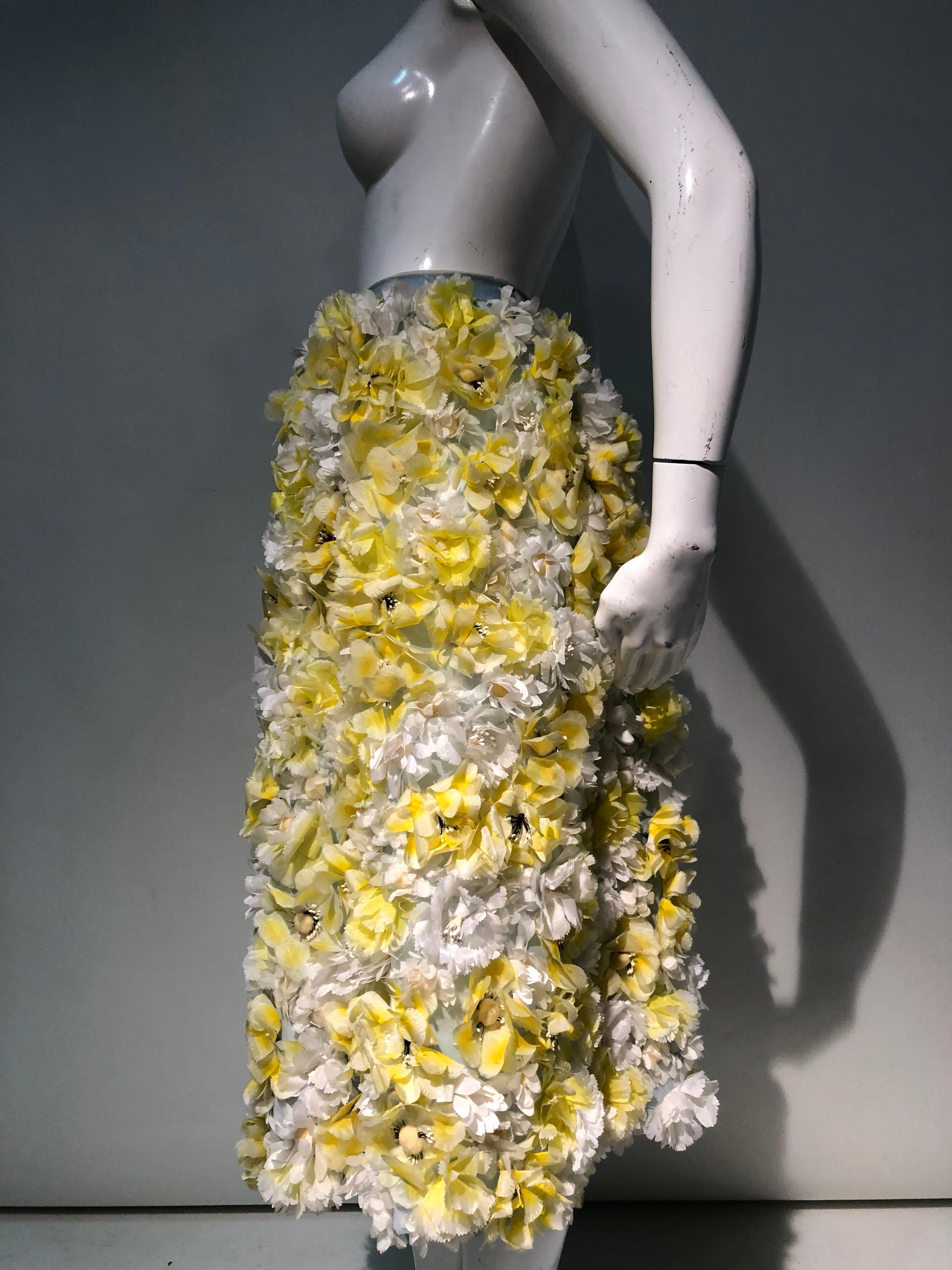 A Spectacular 1960s Adolpho A-line ball skirt constructed of pale blue knit overgrown with a field of yellow and white silk daffodil and anemone blooms! Skirt is lined and has a piped waistline. 