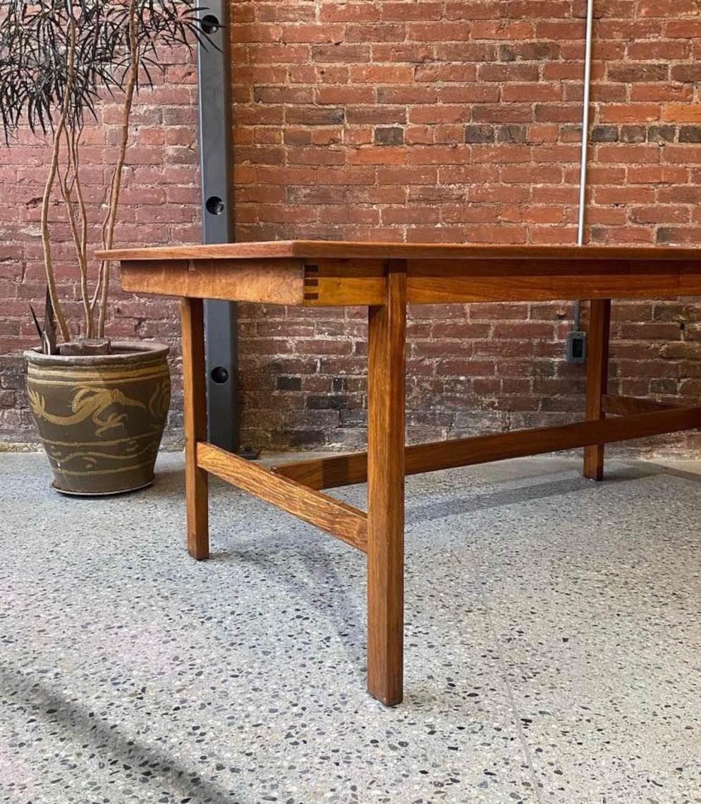 Incredible high quality African teak dining table with built in butterfly leaf. This piece has high quality co strict Oon with a solid wood finger jointed apron, and beautifully figured wood throughout. The entire piece is freshly restored and in