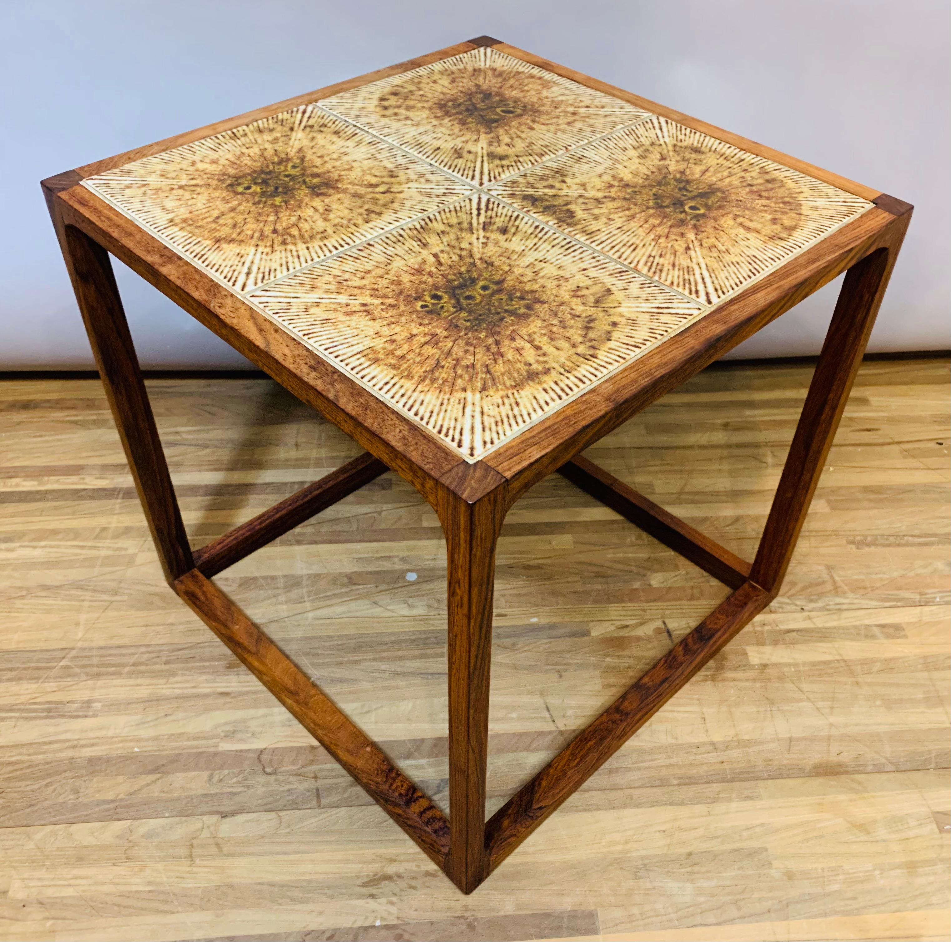 1960s Rosewood tiled topped cubic coffee table with feature chamfered legs and supports. The four brown original tiles compliment the Rosewood beautifully and are certainly of the period. The table is made with solid Rosewood on the legs and
