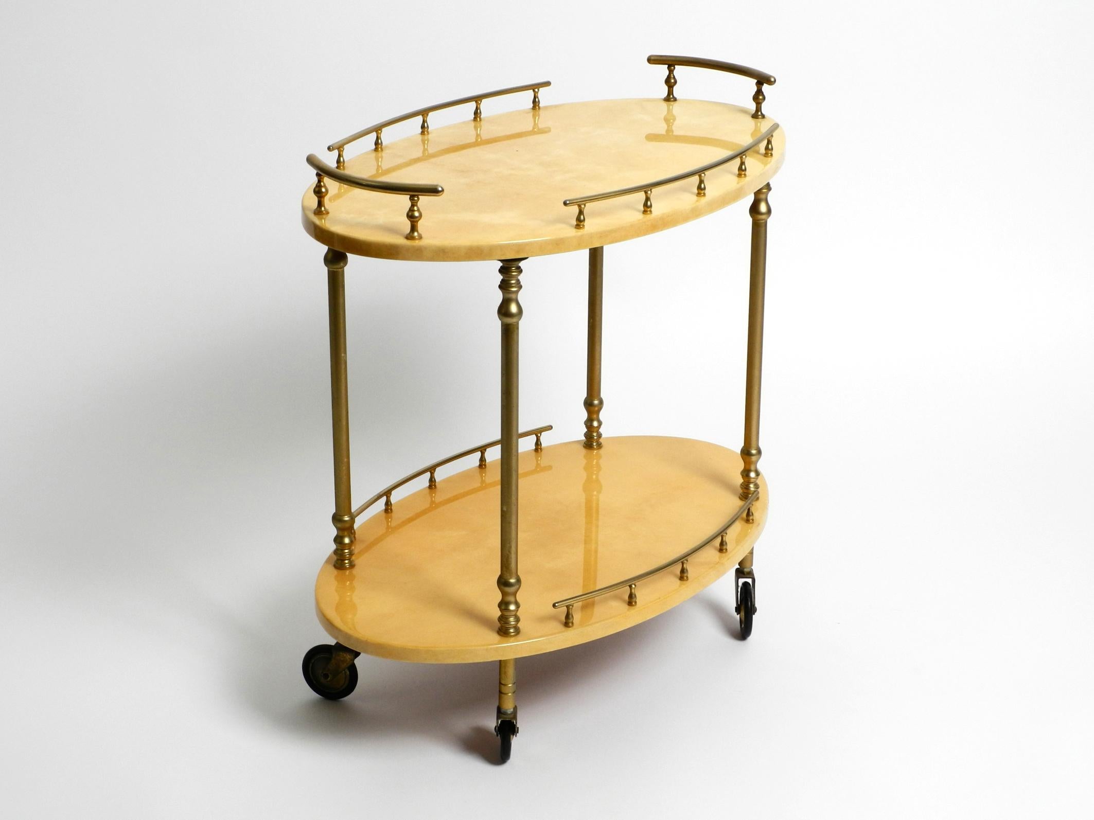 Rare 1960s Aldo Tura wooden serving bar cart
covered with beige goatskin and thick clear varnish.
The high-quality frame is made of brass.
Very elegant design. Made in Milan Italy. Very good, well-kept condition.
No damages to the serving