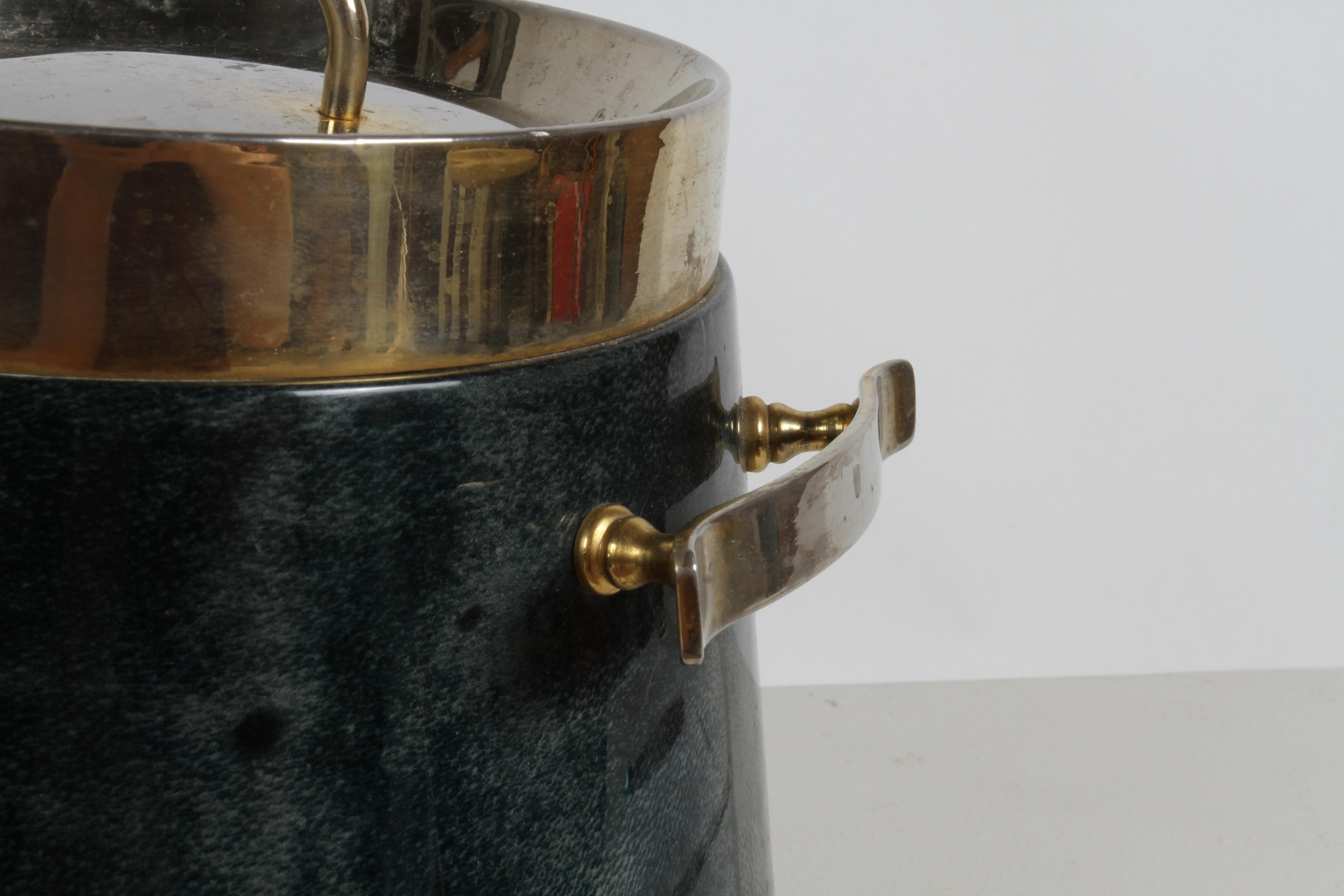 Fabulous 1960s Aldo Tura ice bucket in rich green lacquered goatskin, with gold plated hardware, and glass lined interior. Some wear to gold plating to be expected from use, few dings, Goatskin in very nice condition. Labeled Tura - Italy