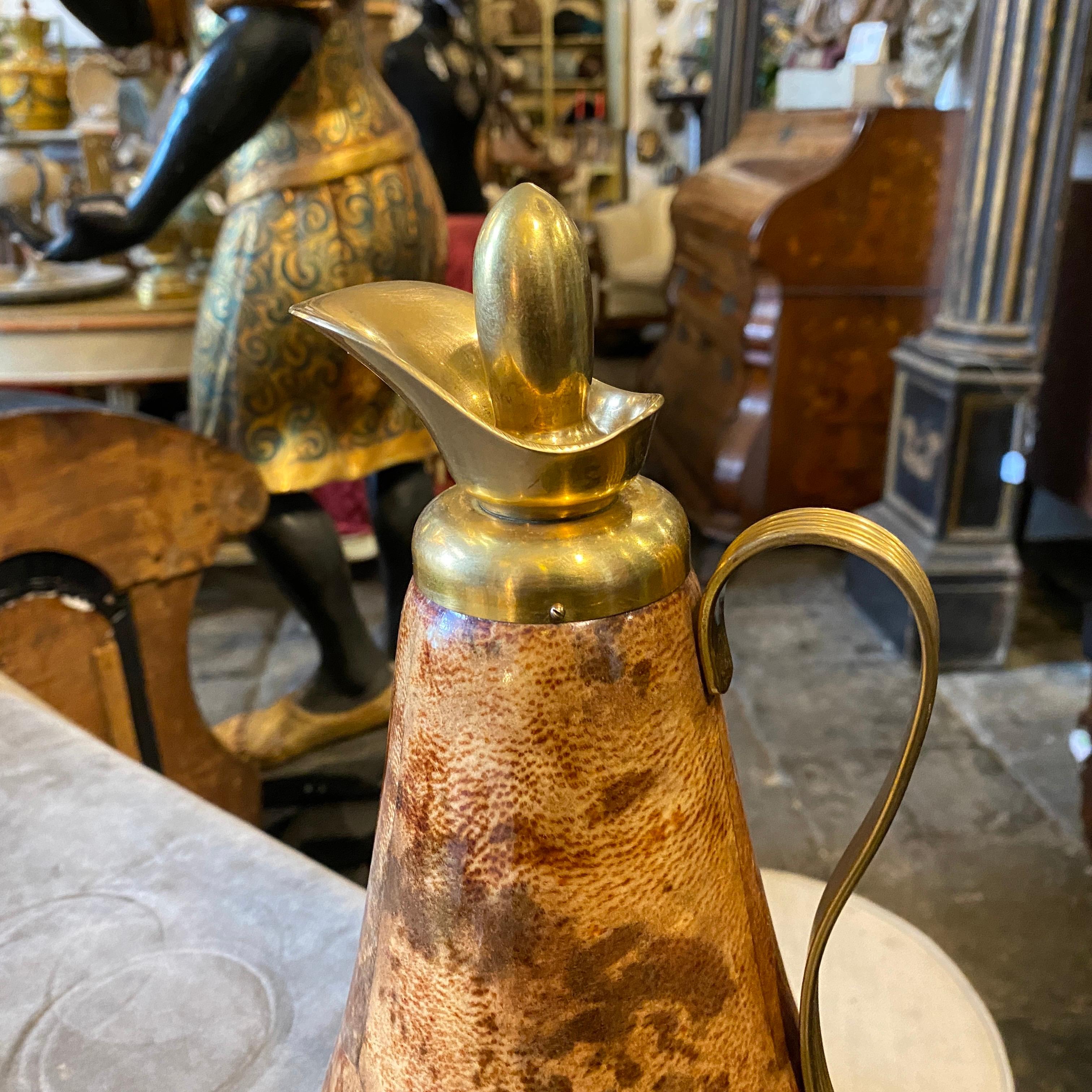 An Aldo Tura pitcher, brown goatskin is in good conditions, solid brass it's in original patina. It's marked Macabo on the bottom.