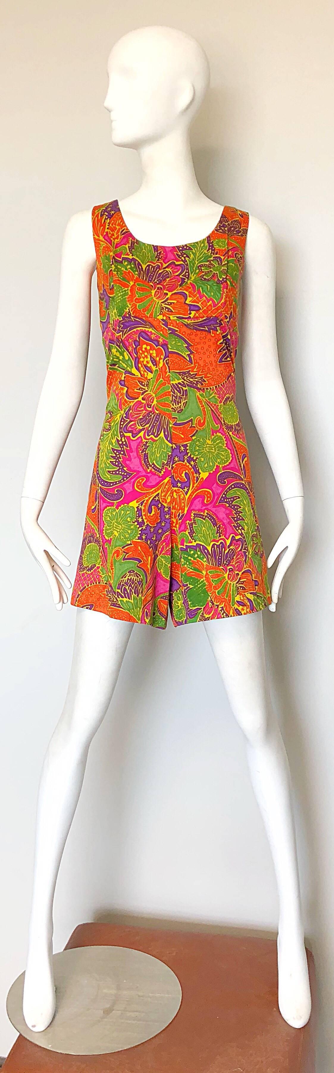 Rare 1960s ALFRED SHAHEEN colorful tropical jumpsuit romper! Features colorful tropical Hawaiian prints throughout. Vibrant colors of orange, purple, hot pink, yellow and green throughout. Full metal zipper up the back with hook-and-eye closure.