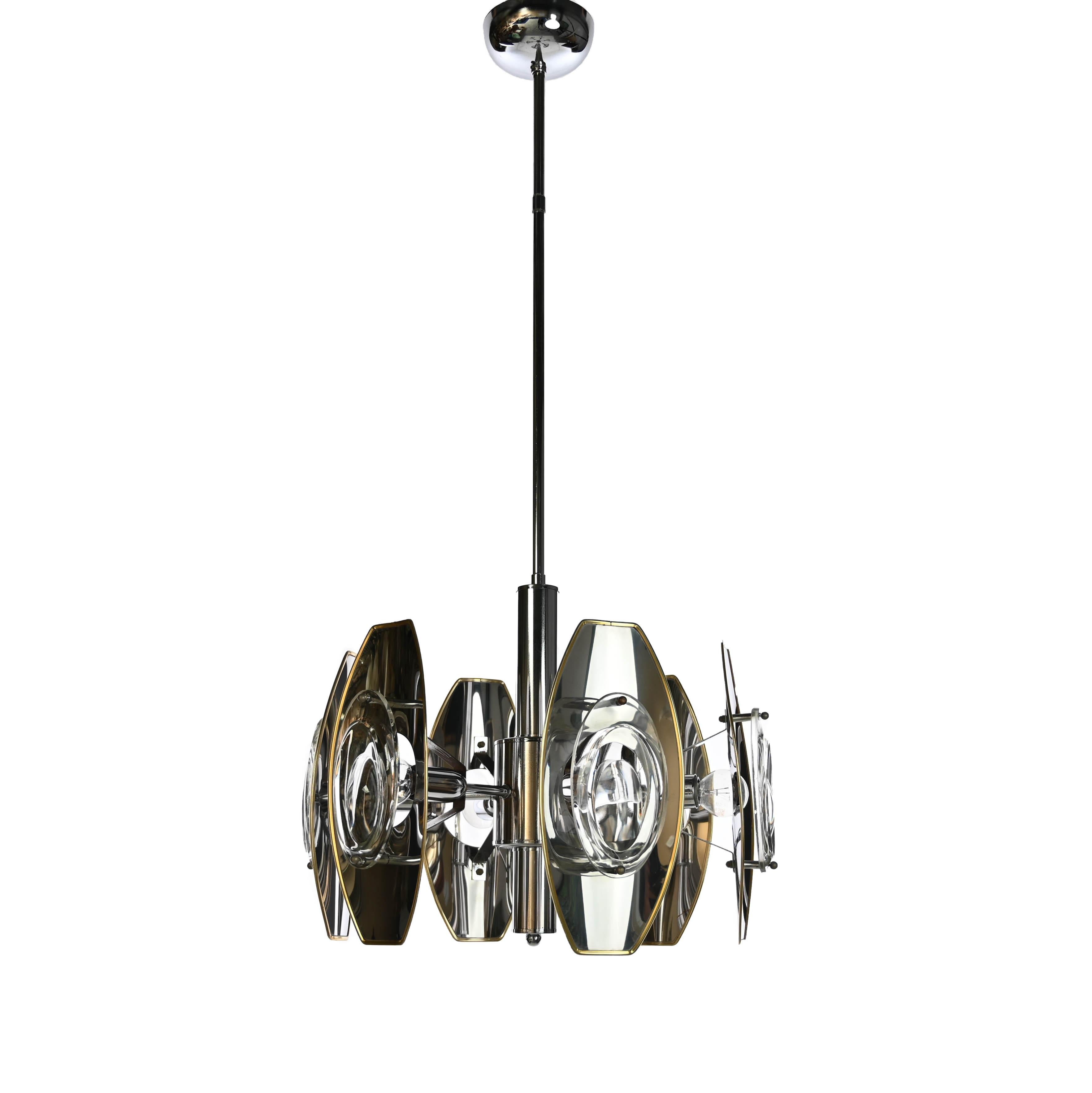 Super stylish and rare metallic lamp by Oscar Torlasco. The 6 chrome armes contain aluminium lamp shades with a gold finish rim which hold 6 large lenses of glass.