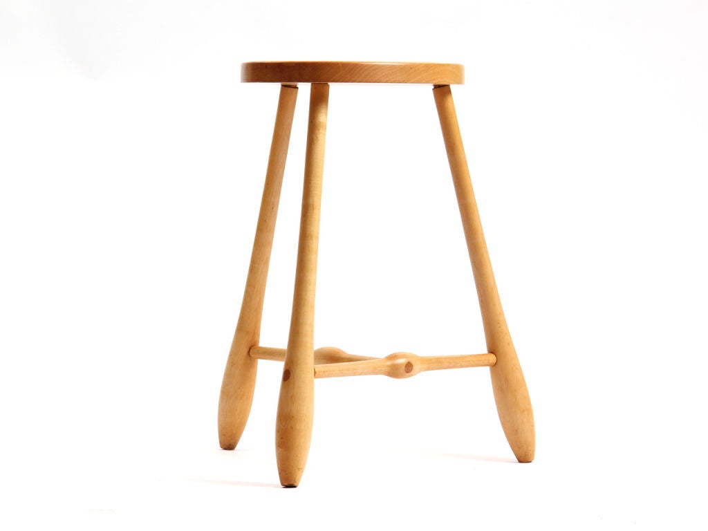 A birch stool with three through tenon joints and swollen dowel legs with sculptural egg shaped seats.