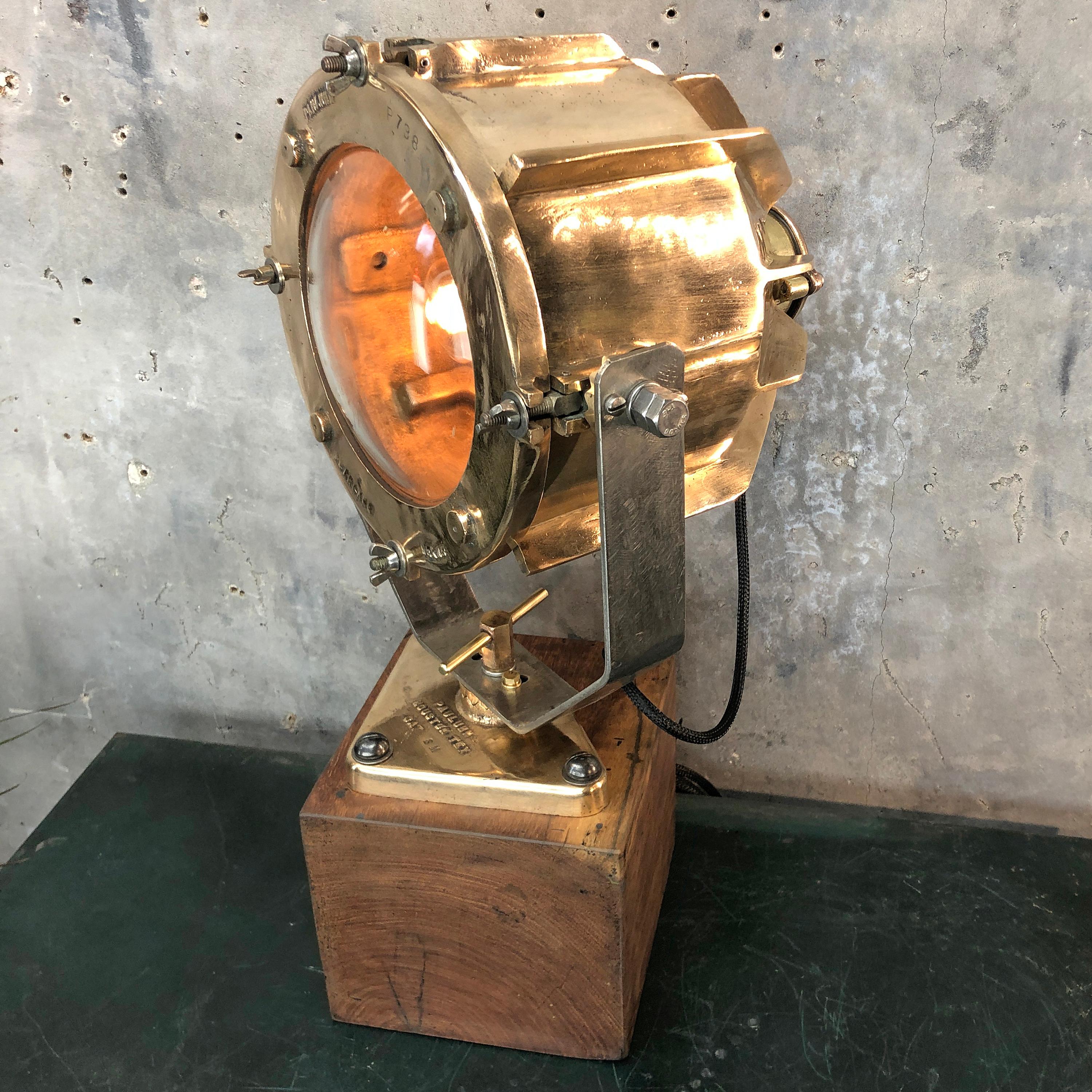 A vintage Industrial table lamp comprised of a solid bronze cargo light and teak timber base.

The lamp was manufactured by Crouse Hinds / Pauluhn, Texas, USA and the base has been made using teak reclaimed from a cargo ship.

The cargo light