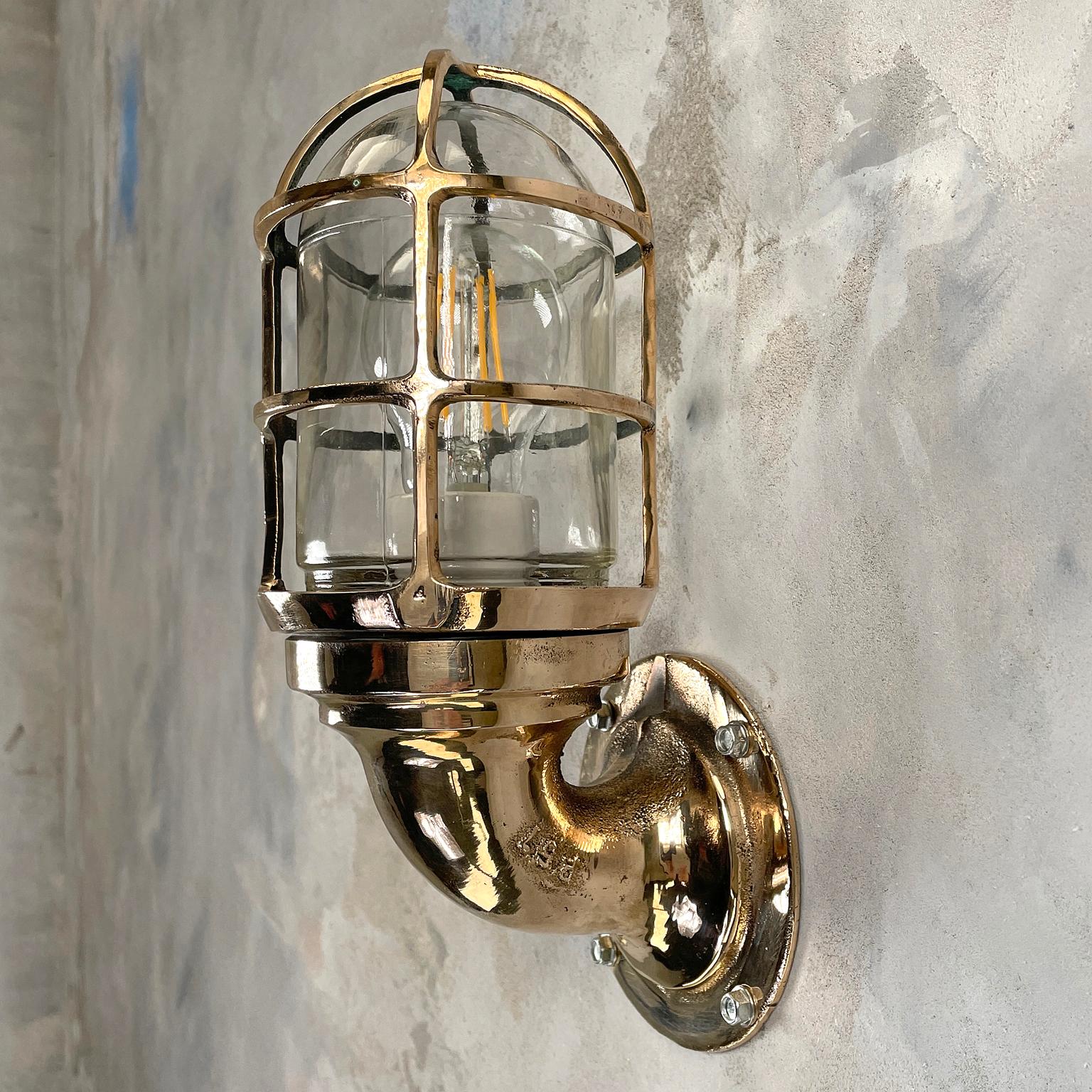 A vintage industrial 1960s Pauluhn bronze 90 degree wall sconce with industrial style cage & glass dome. Manufactured by American Company, Crouse-Hinds. Reclaimed and professionally restored by hand in UK by Loomlight, ready for contemporary