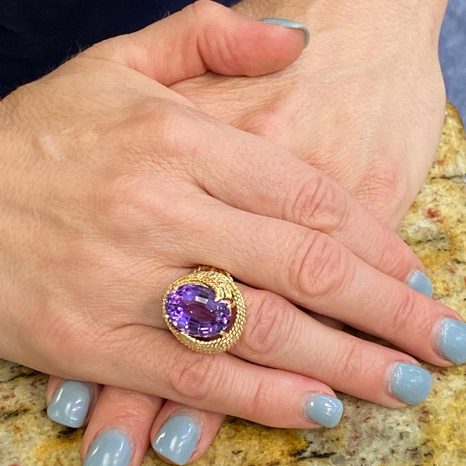 Vintage amethyst ring handcrafted in 14 karat yellow gold. The ring features an approximatey 7.0 carat amethyst gemstone set in a rope textured yellow gold mounting. The amethyst measures 12 x 16mm, and the ring is currently size 7 (can be sized). 