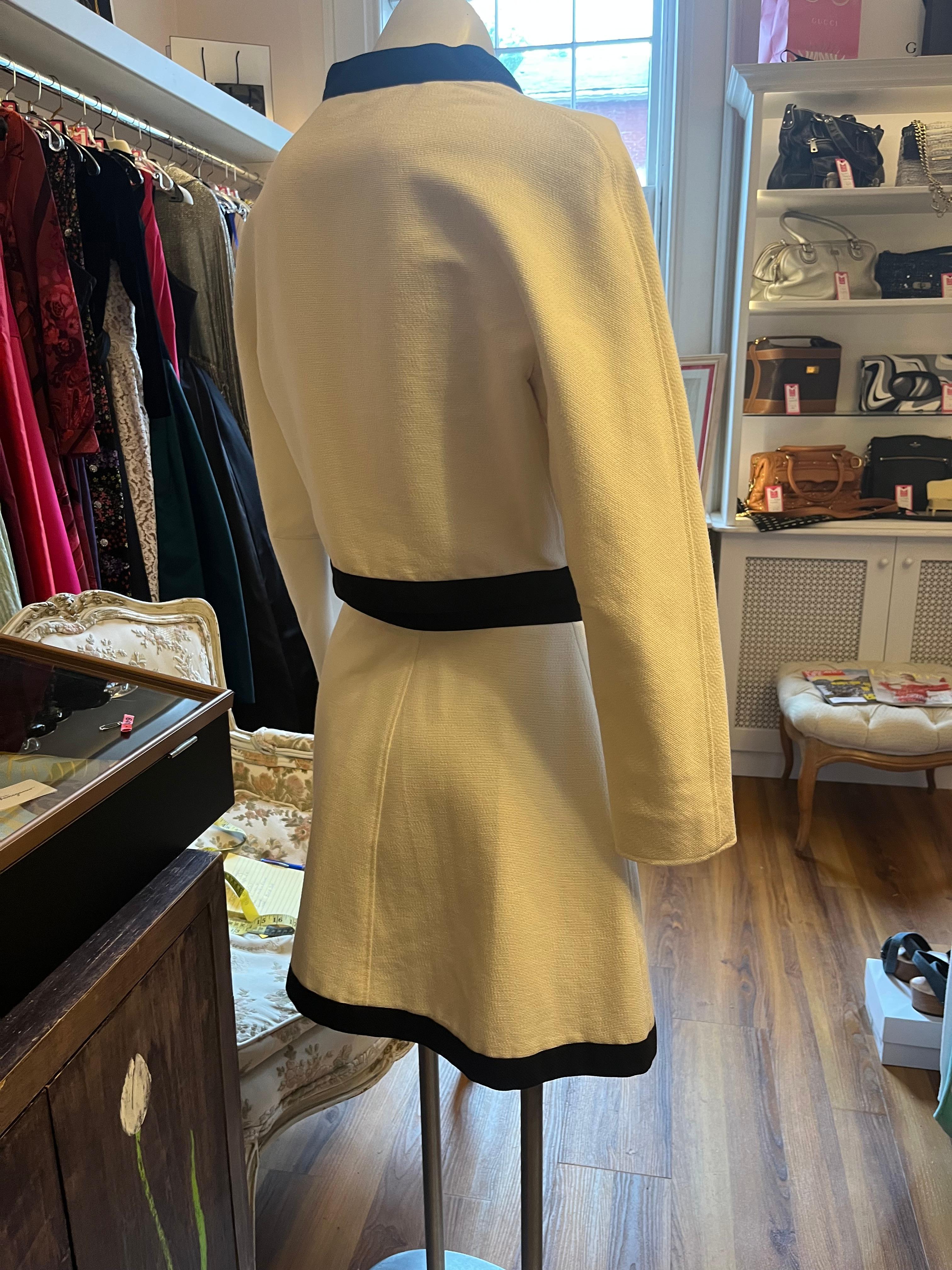 Designed by Avant Garde French Designer Andre Courreges, this white with black trim suit in cotton pique is a very good example of his work.
It is in wonderful condition for its age, and the style is still relevant today.
The jacket has a rounded