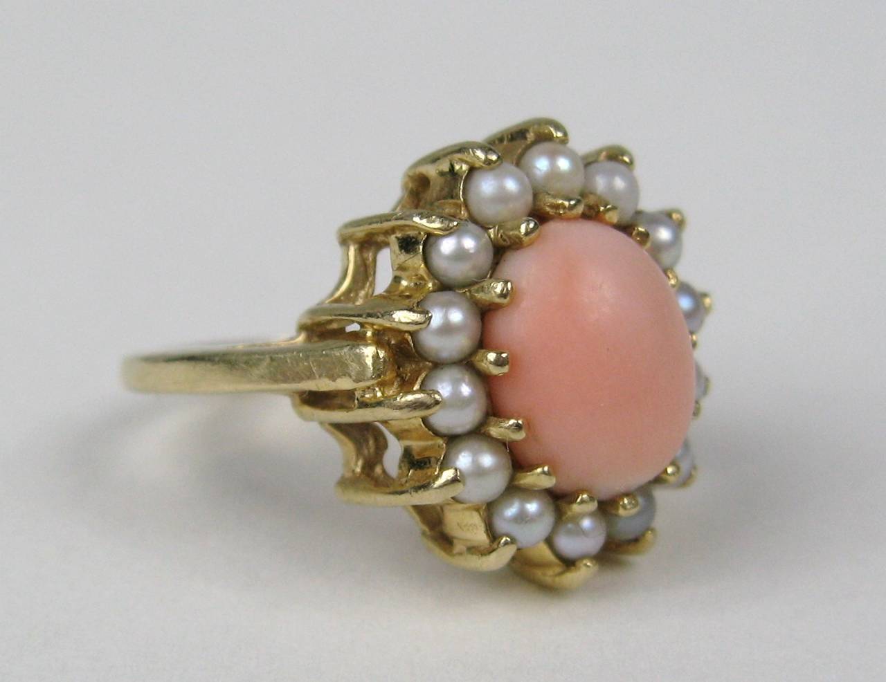 14K Gold Ring, Coral center surrounded by pearls. The Ring is a size 6 and can be sized by us or your jeweler. Ring measures .65 inches top to bottom. This is out of a massive collection of Hopi, Zuni, Navajo, Southwestern, sterling silver, costume