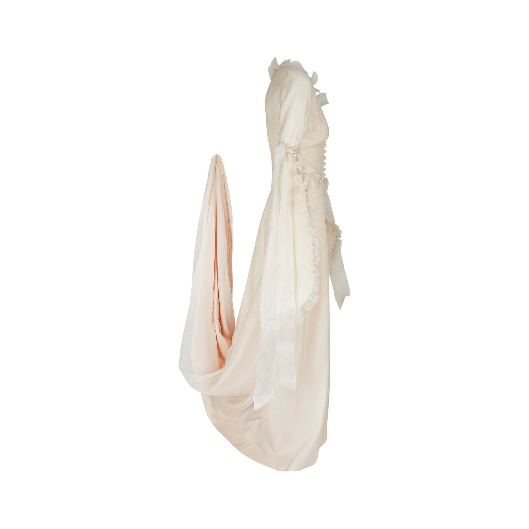 This late 1960s dress by Annacat is really something special and the best we've ever seen from the British design duo Janet Lyle and Maggie Keswick. It is a fairy-tale concoction of cream Georgette overlaid on a peach underdress. It is magnificent