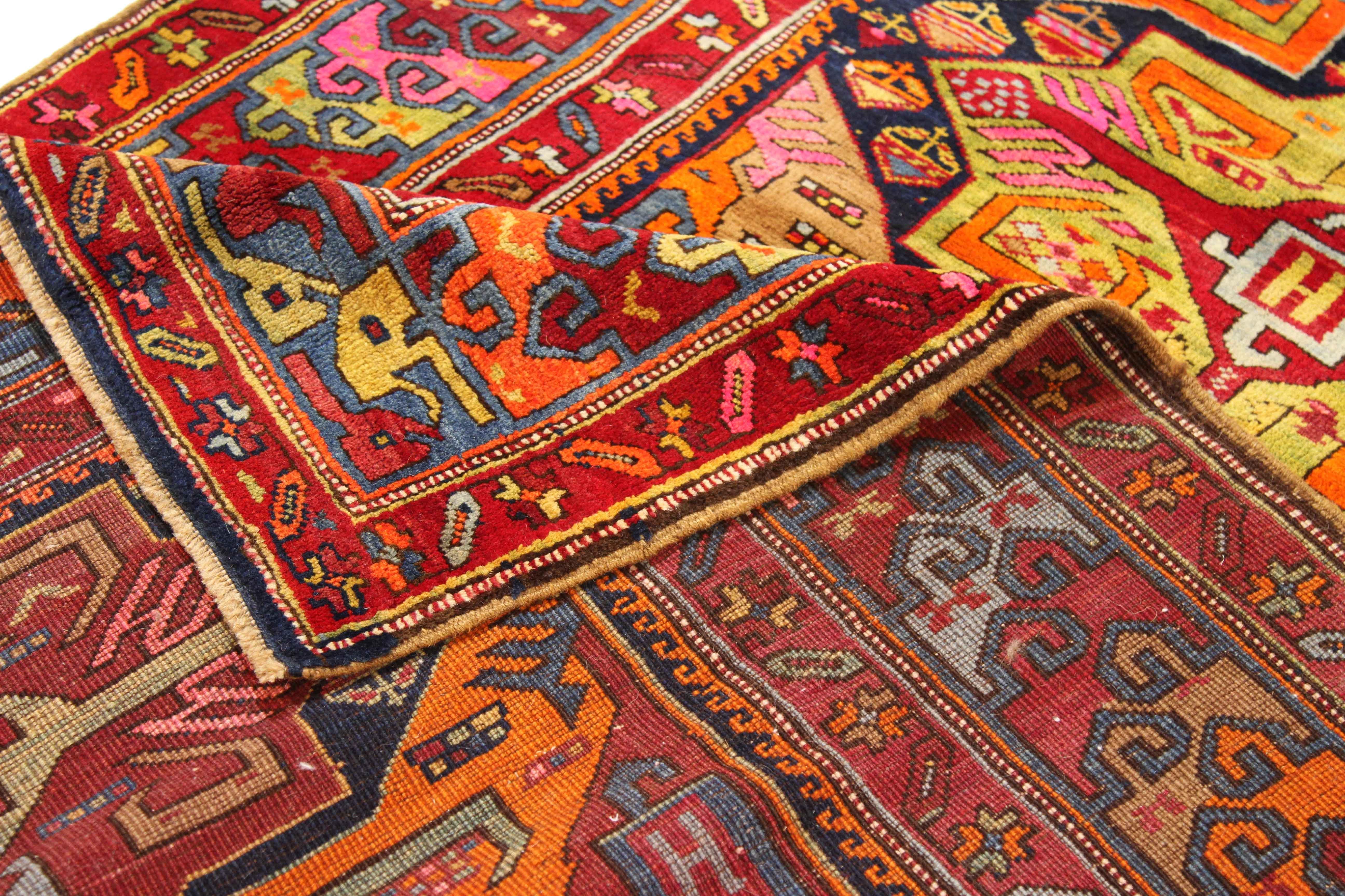 1960s antique wool rug of Persian origin. It features ornate patterns and symbols traditionally found in an Azerbaijan-made carpet. What makes this piece unique is the use of bright, pastel colors that can help accentuate contemporary, bohemian, and