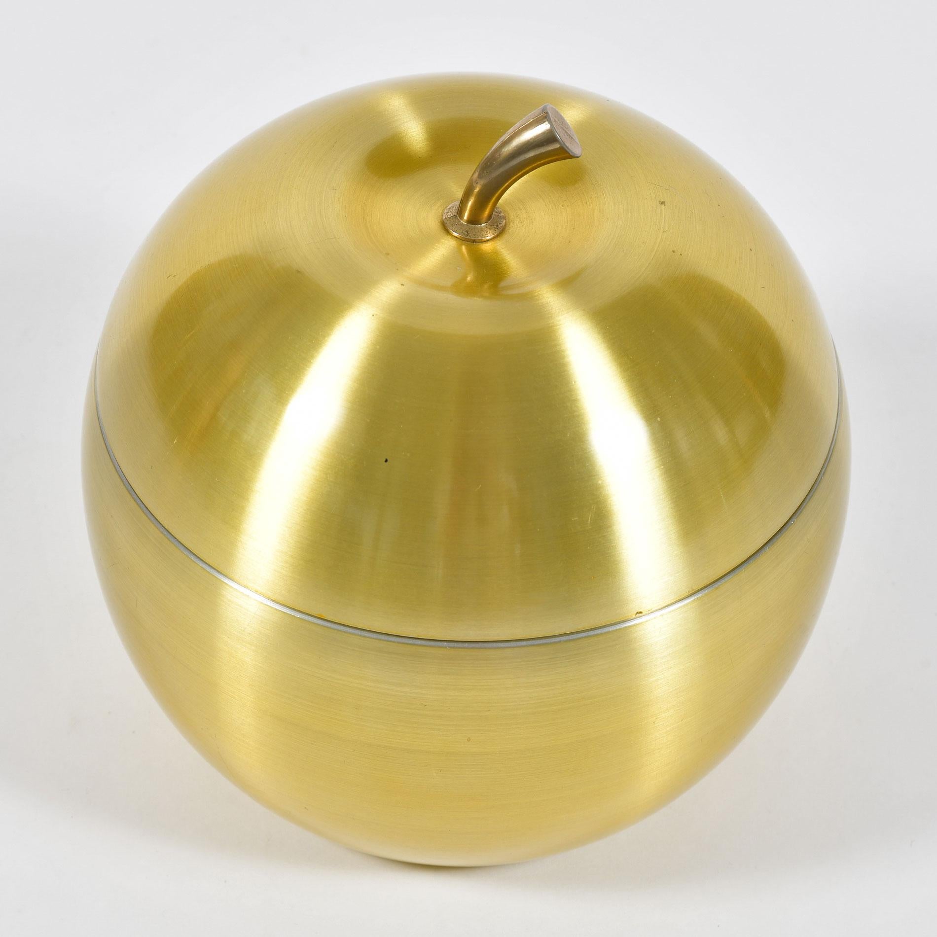 Polished brass ice bucket in the shape of an apple, stamped: 'Novo Industries, Sidney Australia'.