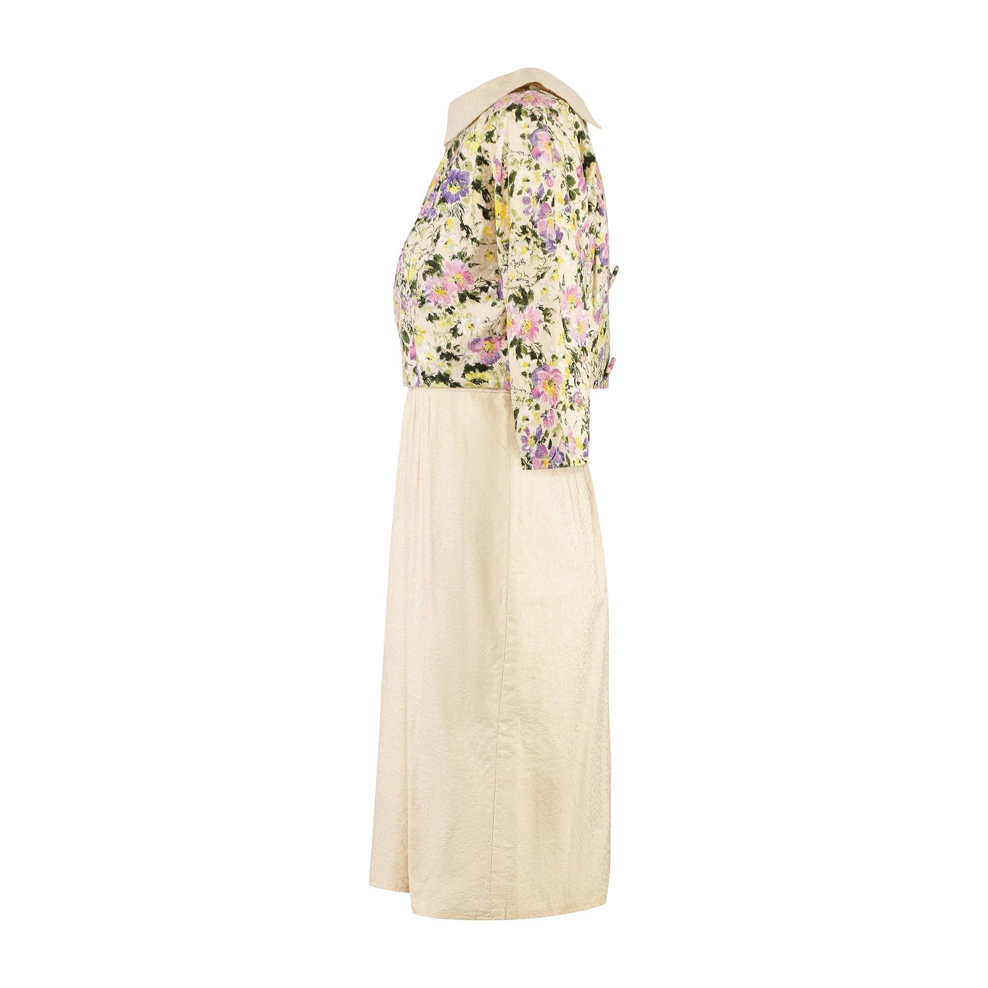 This summery early 1960s two-piece ensemble is composed of a shift-dress and the long-sleeve jacket which sits over it. It is of excellent manufactured quality and most likely made for a good American department store although it has lost its labels