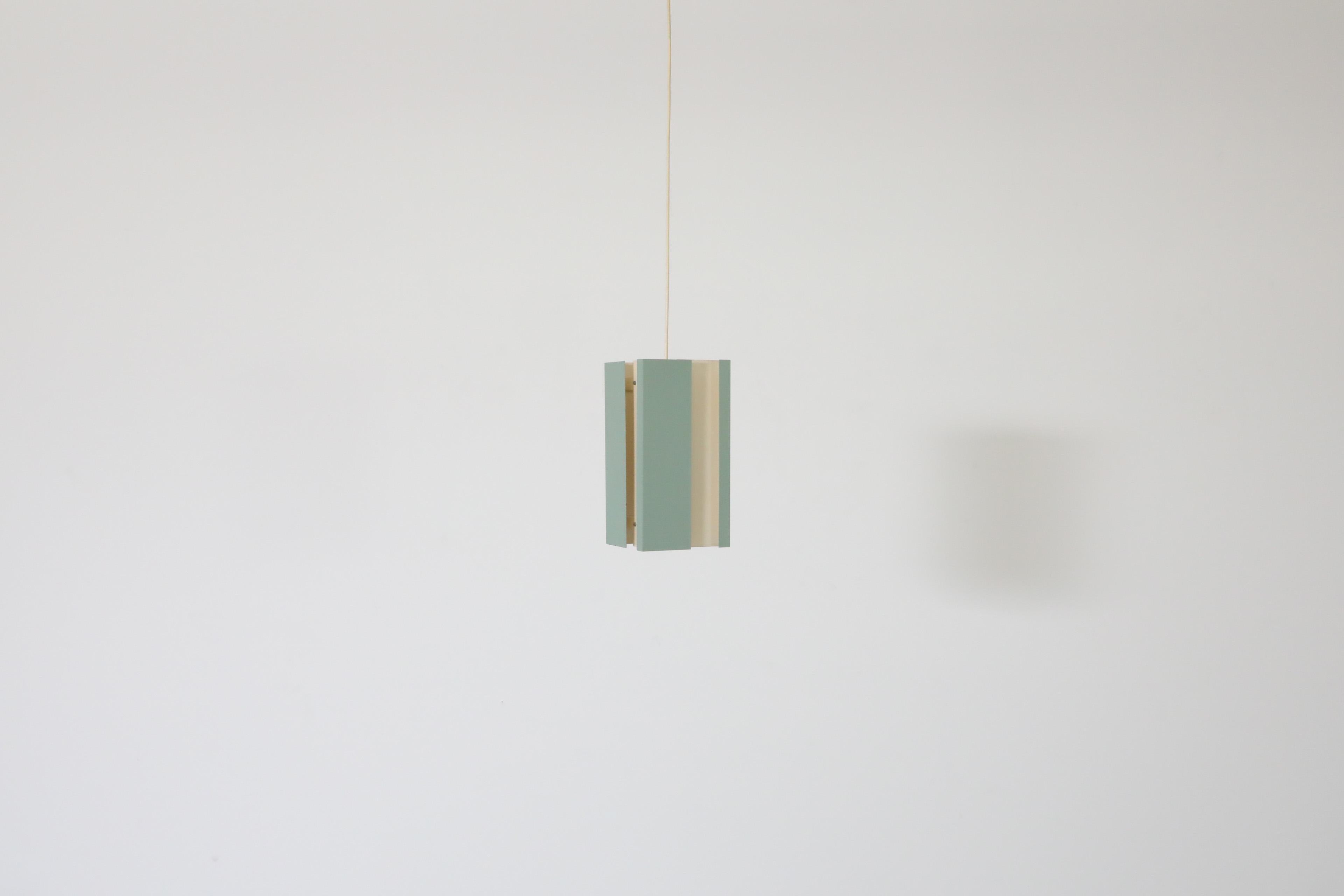 Mid-century 'Model 4101' Pendant light by J.J.M. Hoogervorst for Dutch lighting manufacturer Anvia in white and aqua colored enameled metal ceiling pendant with geometric design. Comes with a European white plastic canopy. In vintage condition with