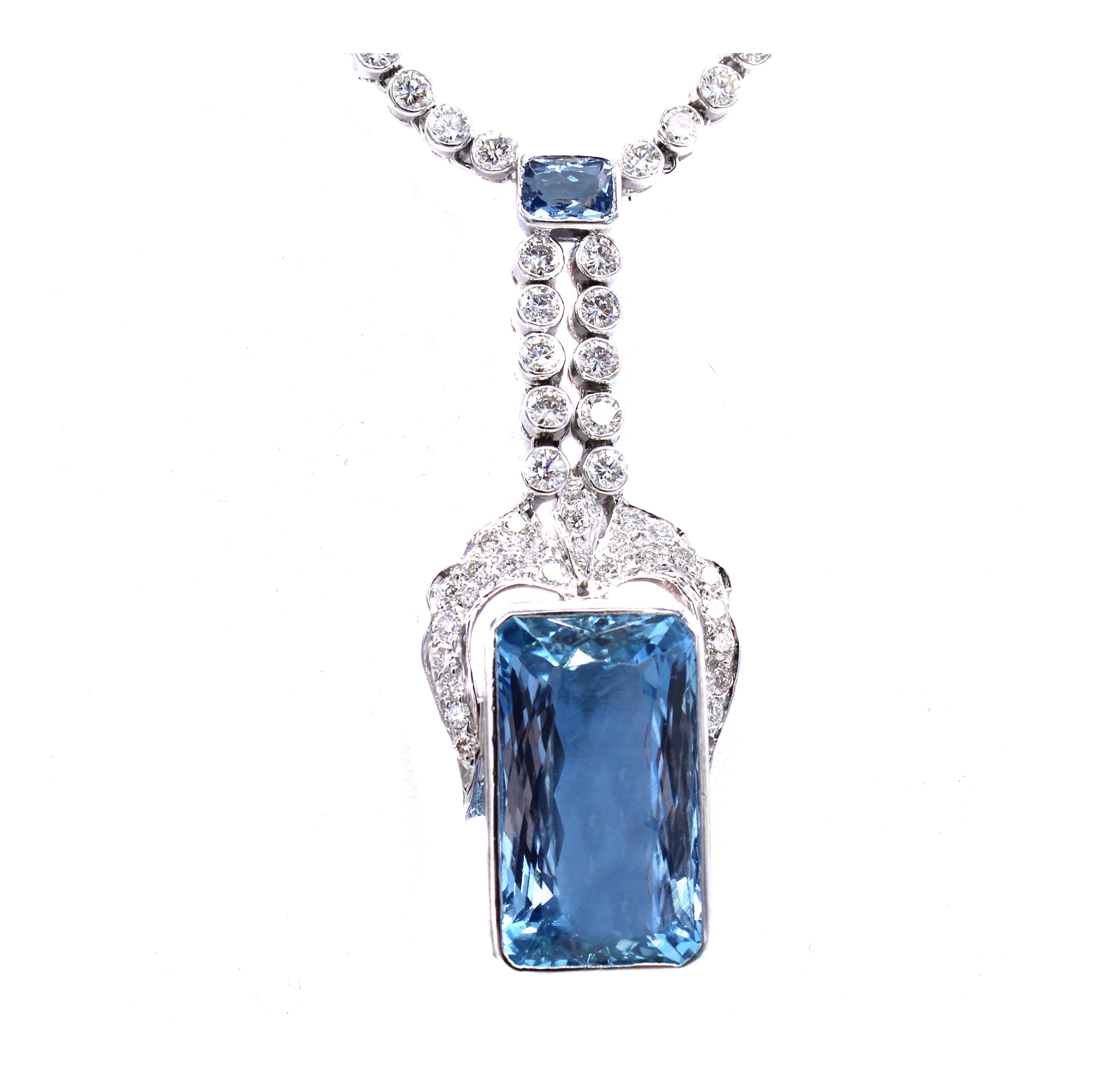 Beautifully designed and masterfully hand-crafted this chic 1960s necklace features intense sky-blue aquamarines and bright white round brilliant cut diamonds. The largest of the aquamarines is bezel set in the flexible pendant element at the base